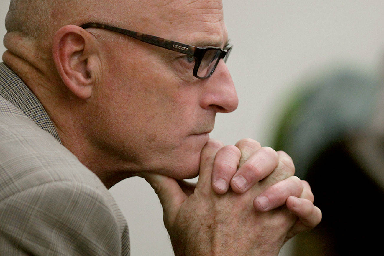 Sitting in the gallery, Snohomish County Prosecuting Attorney Mark Roe listens to opening statements in a trial in Snohomish County Superior Court in 2012. (Mark Mulligan / Herald file)