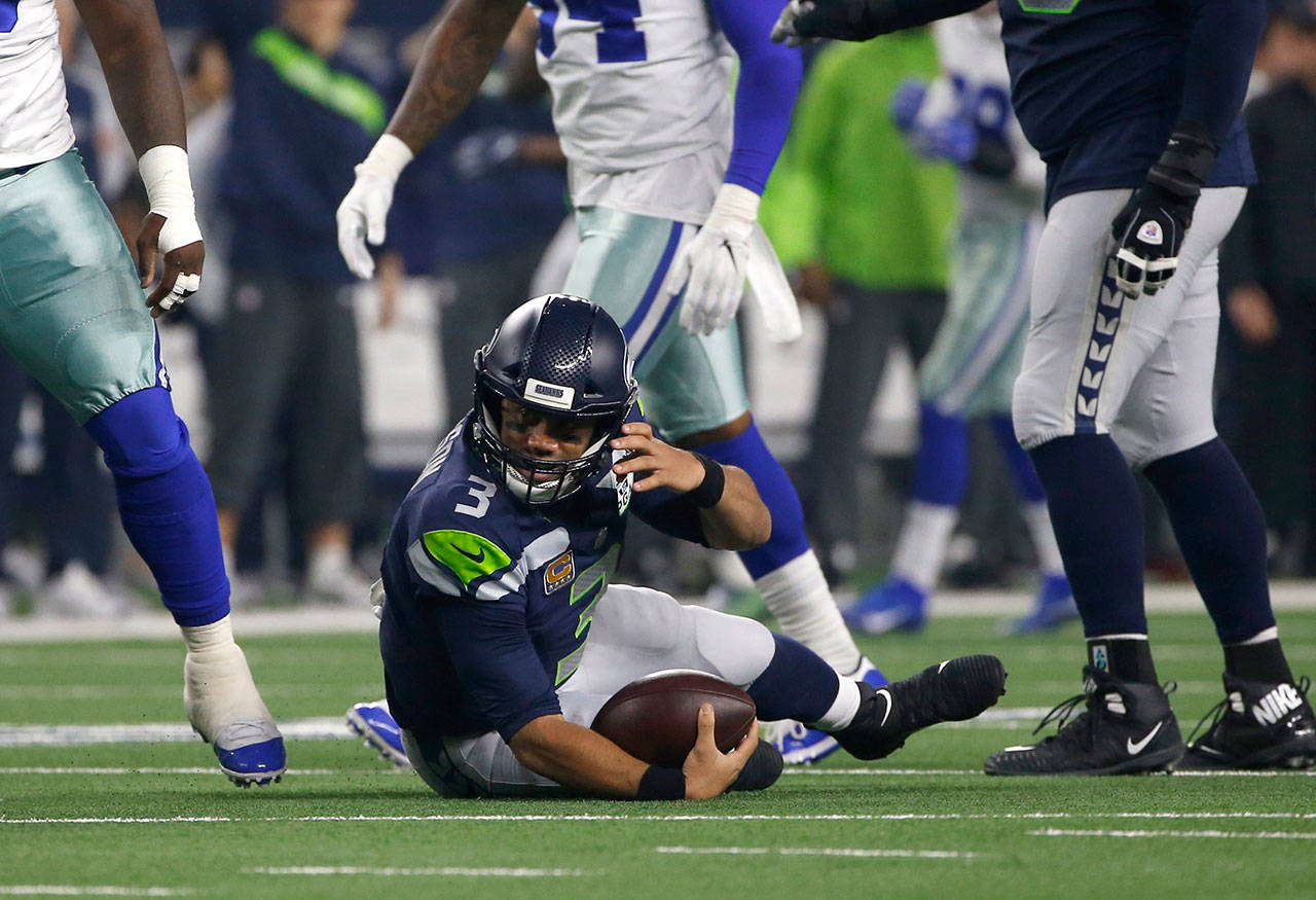 Seahawks quarterback Russell Wilson (3) lays on the field after being sacked by the Cowboys during an NFC wild-card game on Jan. 5, 2019, in Arlington, Texas. (AP Photo/Ron Jenkins)