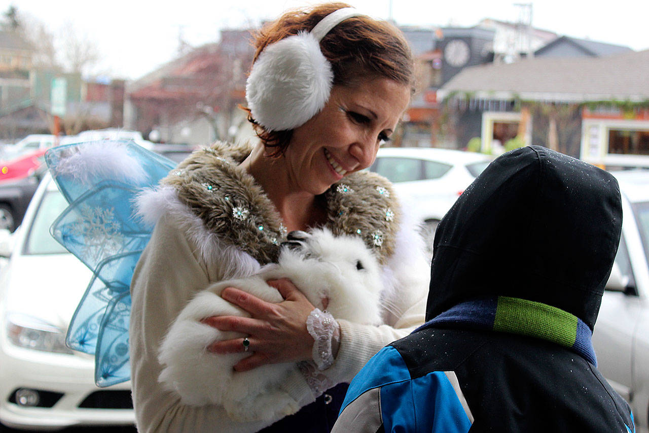 Hahna Luna shows off her bunny, Sebastian, to Langley visitors off the Clipper Christmas ship in December. (Patricia Guthrie / Whidbey New Group)