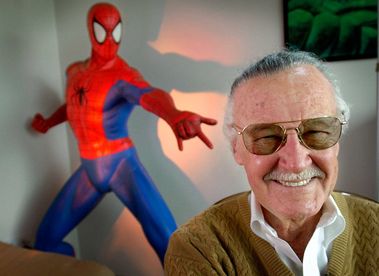 Stan Lee, creator of comic-book franchises such as “Spider-Man,” “The Incredible Hulk” and “X-Men,” poses near a Spider-Man figure in his Santa Monica, California, office in 2002. Friends, fans and family of Stan Lee will gather in Hollywood on Jan. 30 for a memorial honoring the life and work of late Marvel Comics mogul. (Reed Saxon / AP file)