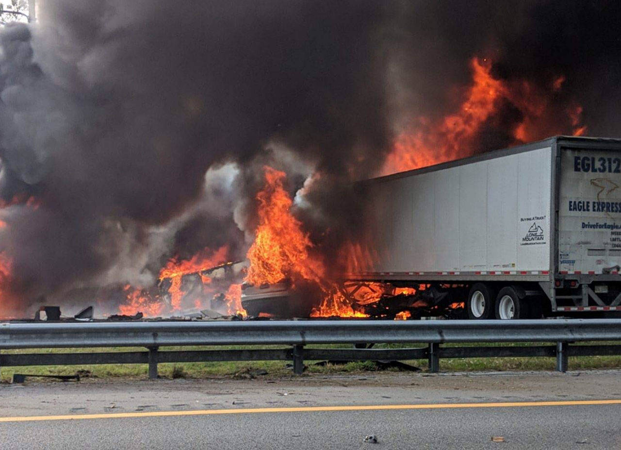 Flames engulf vehicles after a fiery crash along Interstate 75 on Jan. 3 near Gainesville, Florida. A church van packed with children was headed to Walt Disney World when it got caught in a fiery pileup involving two 18-wheelers. Seven people, including five of the children, died in the crash. (WGFL-Gainesville via AP, file)