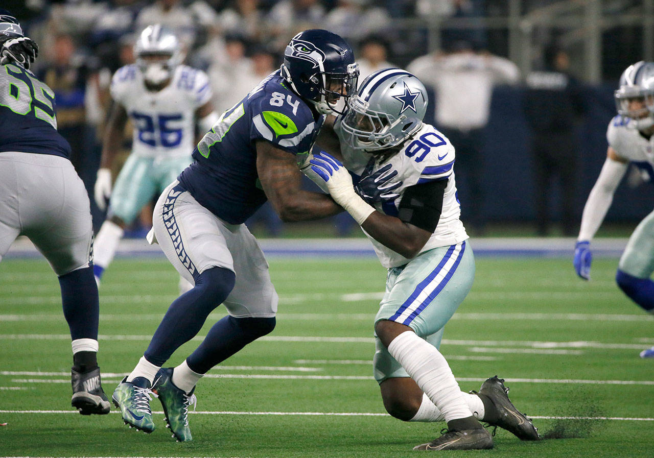 Seattle’s Ed Dickson works against Dallas’ DeMarcus Lawrence during a Jan. 5 game in Arlington, Texas.(AP Photo/Roger Steinman)