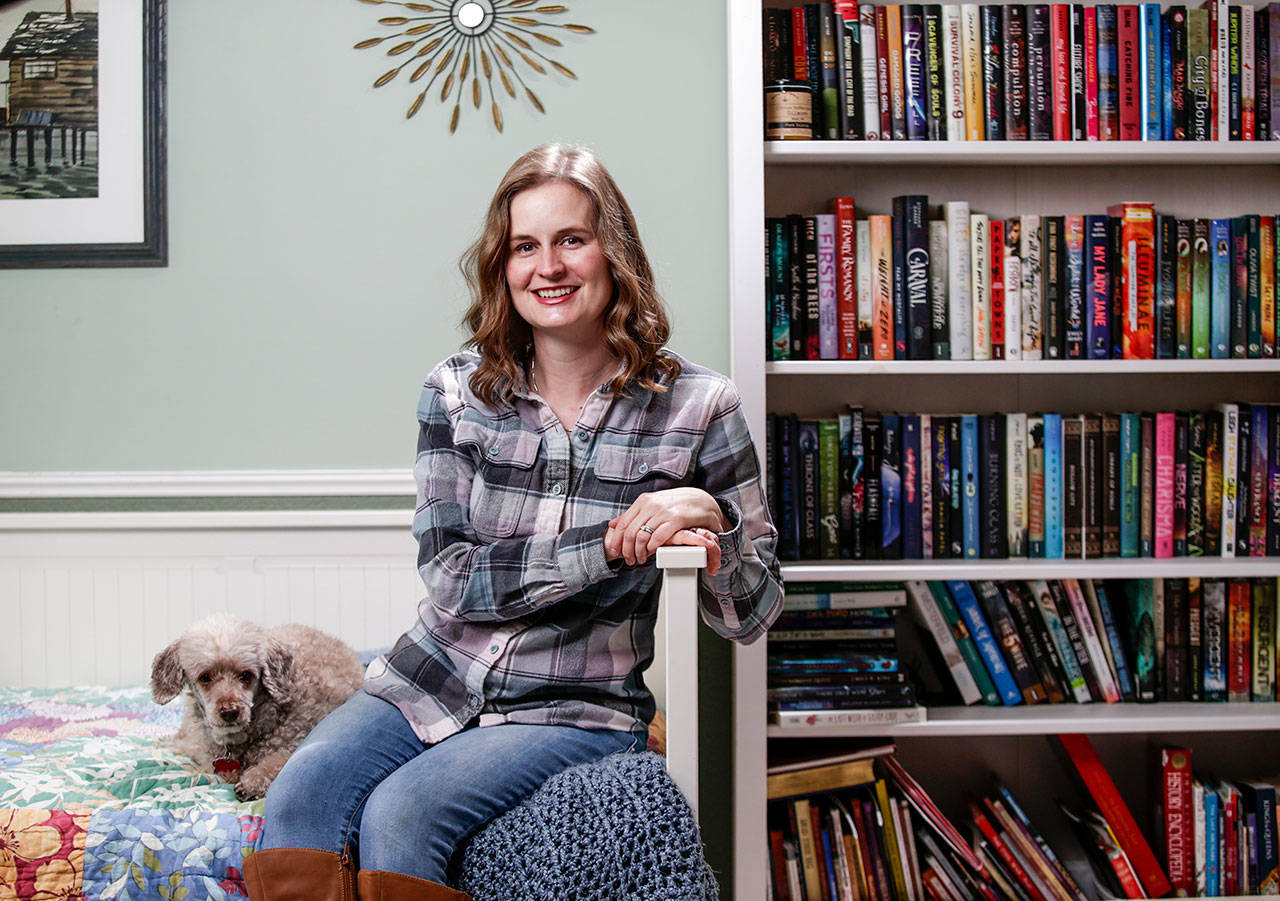 “The Puritan Coven” series by Jennifer Bardsley (aka Louise Cypress) kicks off with “Bite Me.” She’s seen here in her Edmonds home with Merlin the poodle. (Andy Bronson / The Herald)