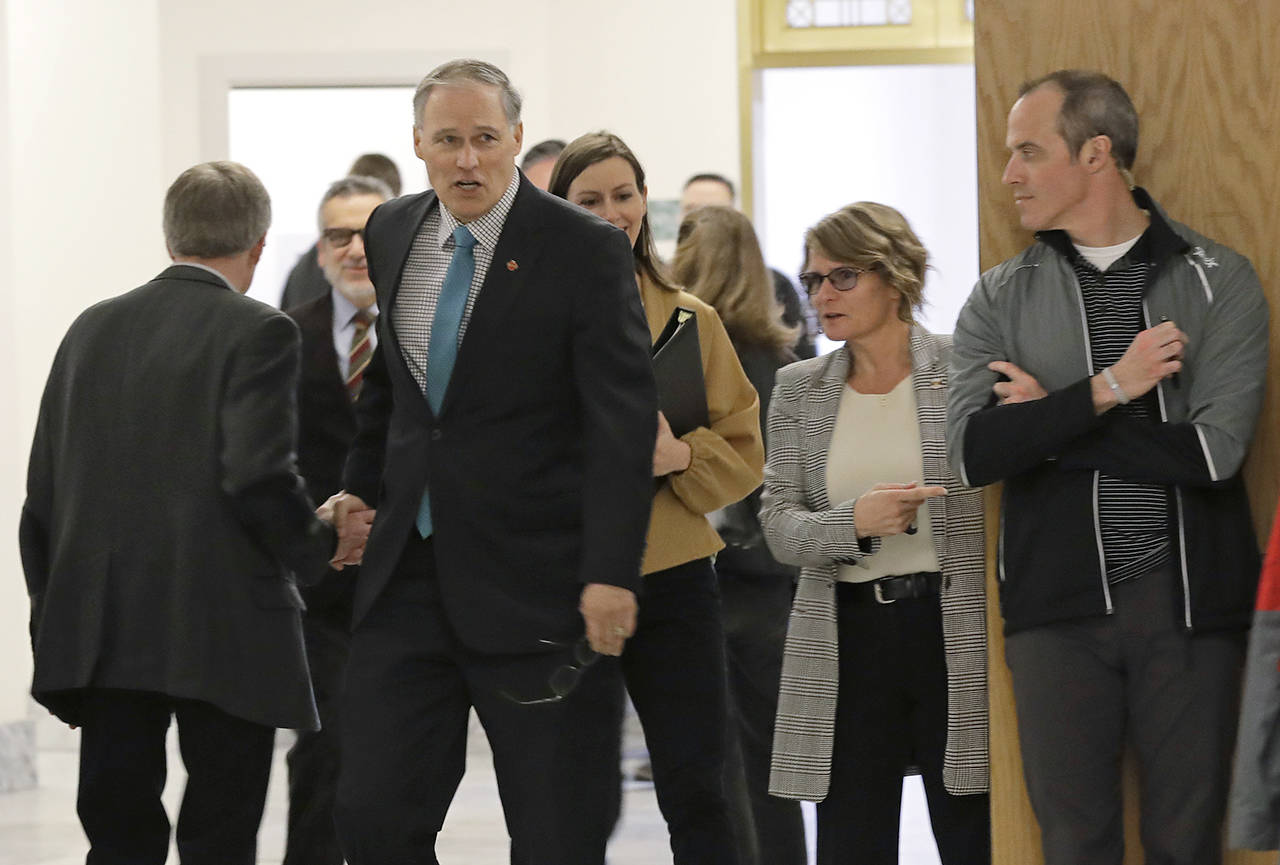 Washington Gov. Jay Inslee arrives to speak at the Associated Press Legislative Preview on Thursday at the Capitol in Olympia. (AP Photo/Ted S. Warren)