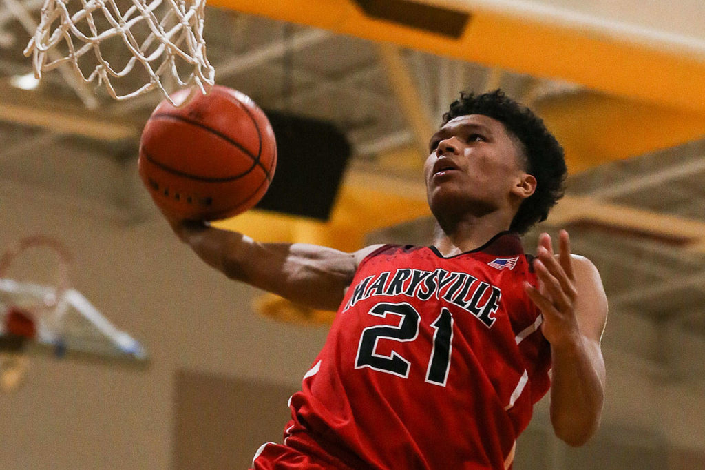 Marysville-Pilchuck’s RaeQuan Battle winds up for a dunk December 14, 2018, at Edmonds-Woodway High School in Edmonds. (Kevin Clark / The Herald)
