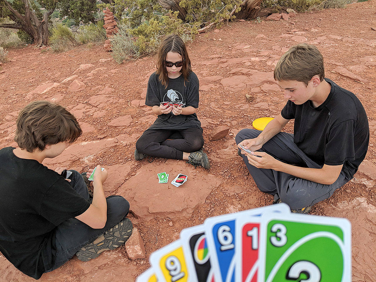 Iden, Erysse and Aren Elliott play a round of Uno at the top of Sugarloaf Loop Trail in Sedona, Arizona. (Christopher Elliott)