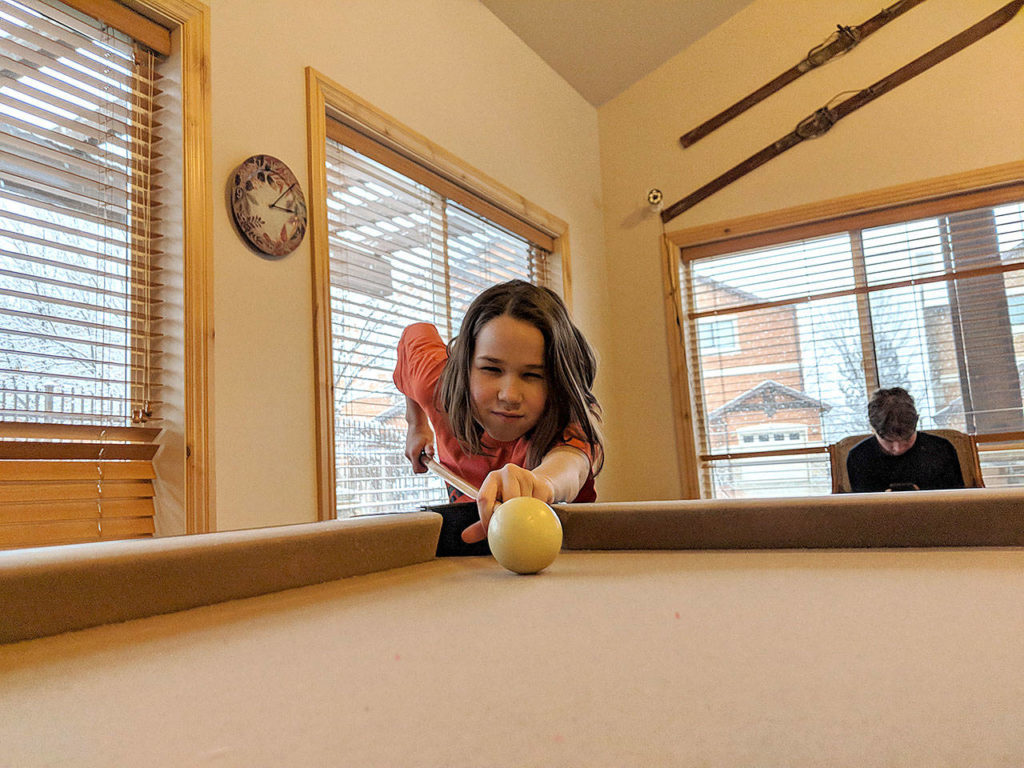 Erysse Elliott plays pool at the Elliott family’s rental in Ogden, Utah. (Christopher Elliott)

