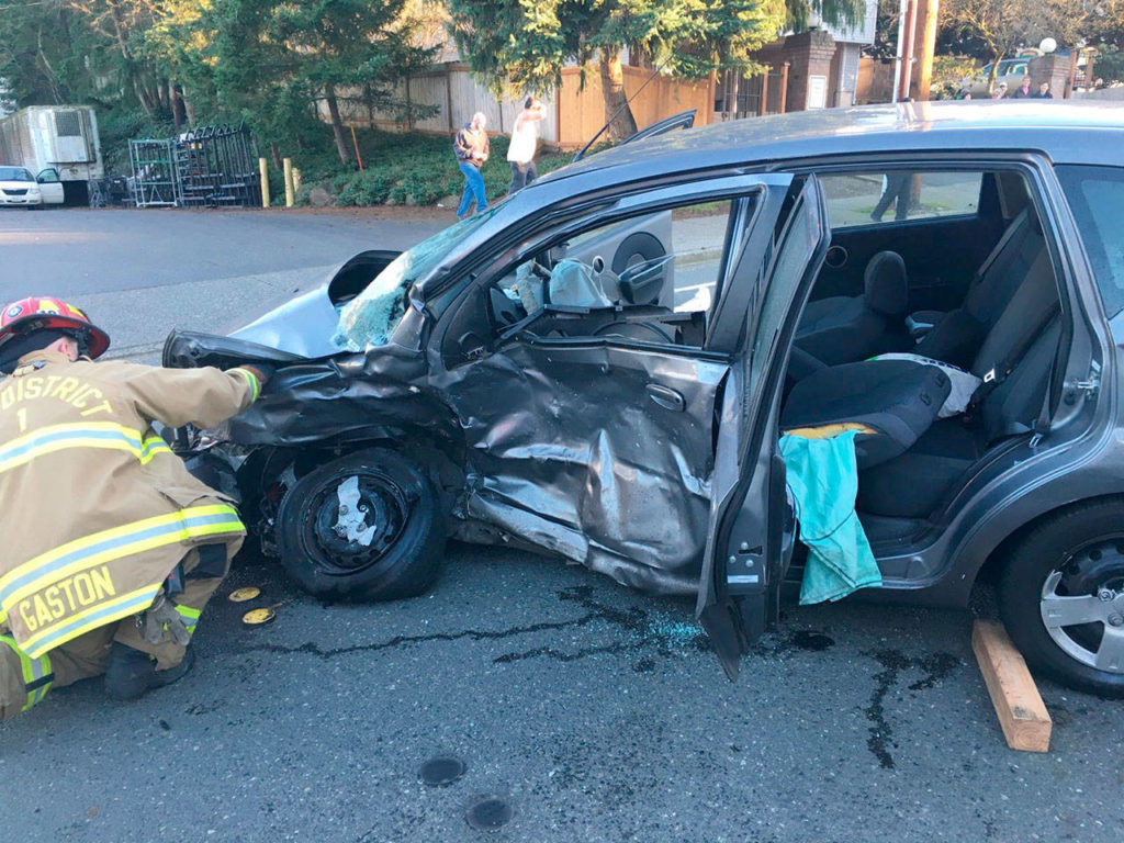 A South Snohomish County Fire & Rescue firefighters inspects the wreckage of a car that was involved in a crash Sunday in Lynnwood. (South Snohomish County Fire Rescue)
