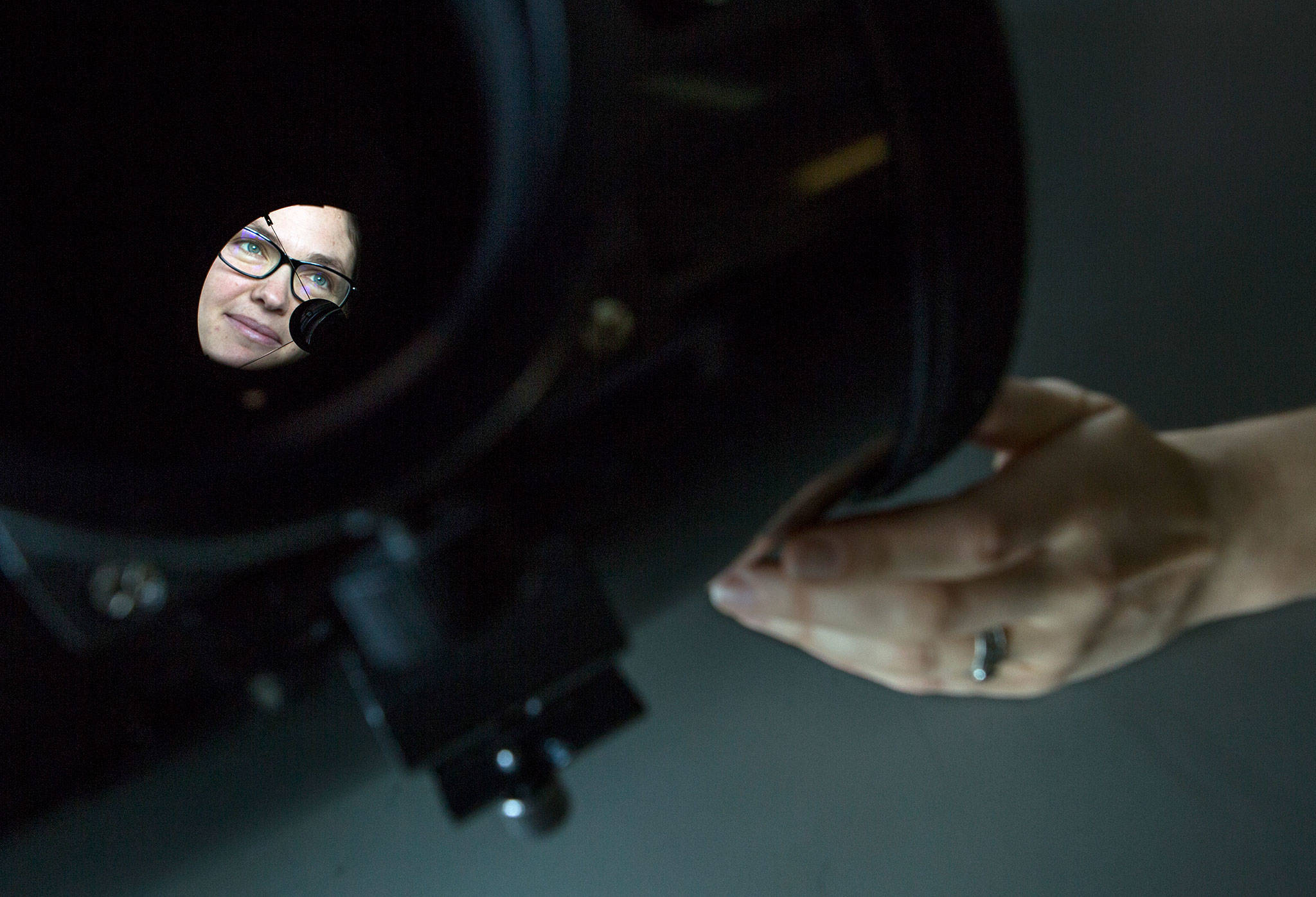 Physicist Joey Shapiro Key is seen through a Celestron telescope in her lab at the University of Washington Bothell campus. (Olivia Vanni / The Herald)