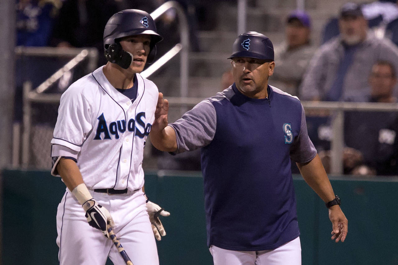 Jose Moreno (right) is entering his fifth season as manager of the Everett AquaSox. (Kevin Clark / The Herald)