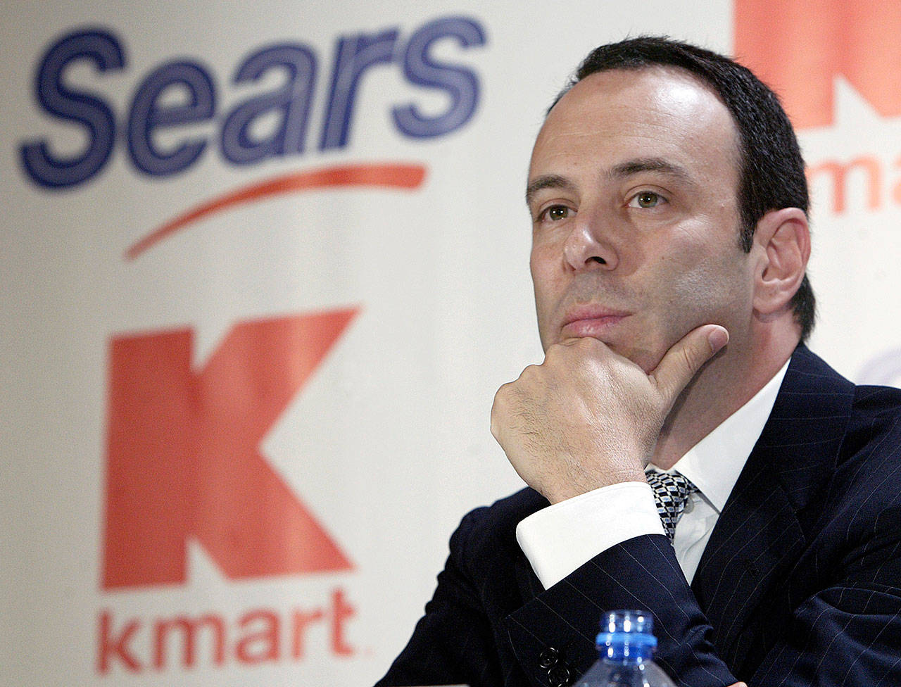 Kmart Chairman Edward Lampert listens during a news conference in 2004 in New York to announce the merger of Kmart and Sears. (Gregory Bull / AP file)