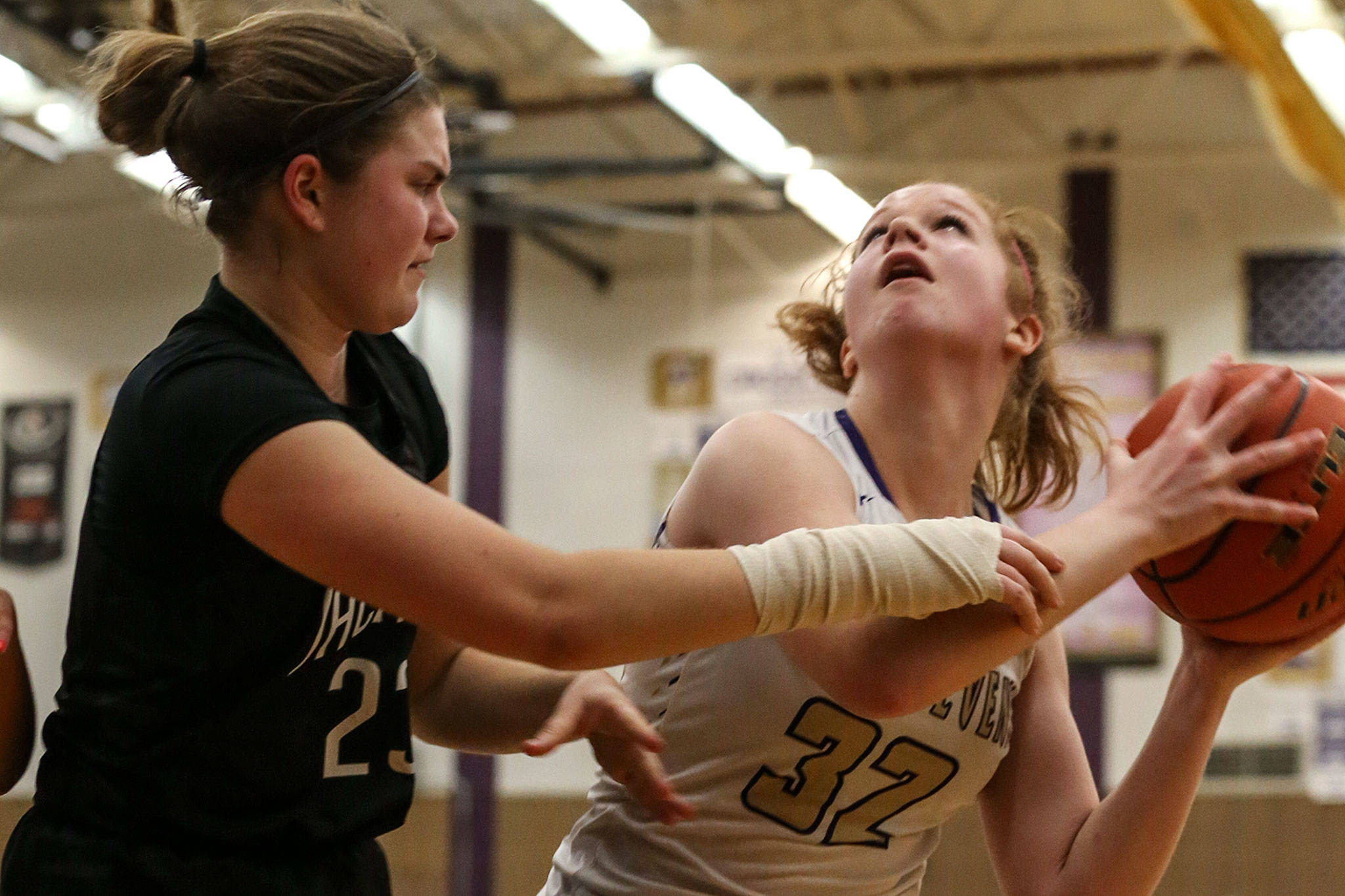 Lake Stevens’ Cori Wilcox (right) looks to score with Jackson’s Olivia Skibiel defending during the Vikings’ 62-39 win Tuesday night at Lake Stevens High School. (Kevin Clark / The Herald)