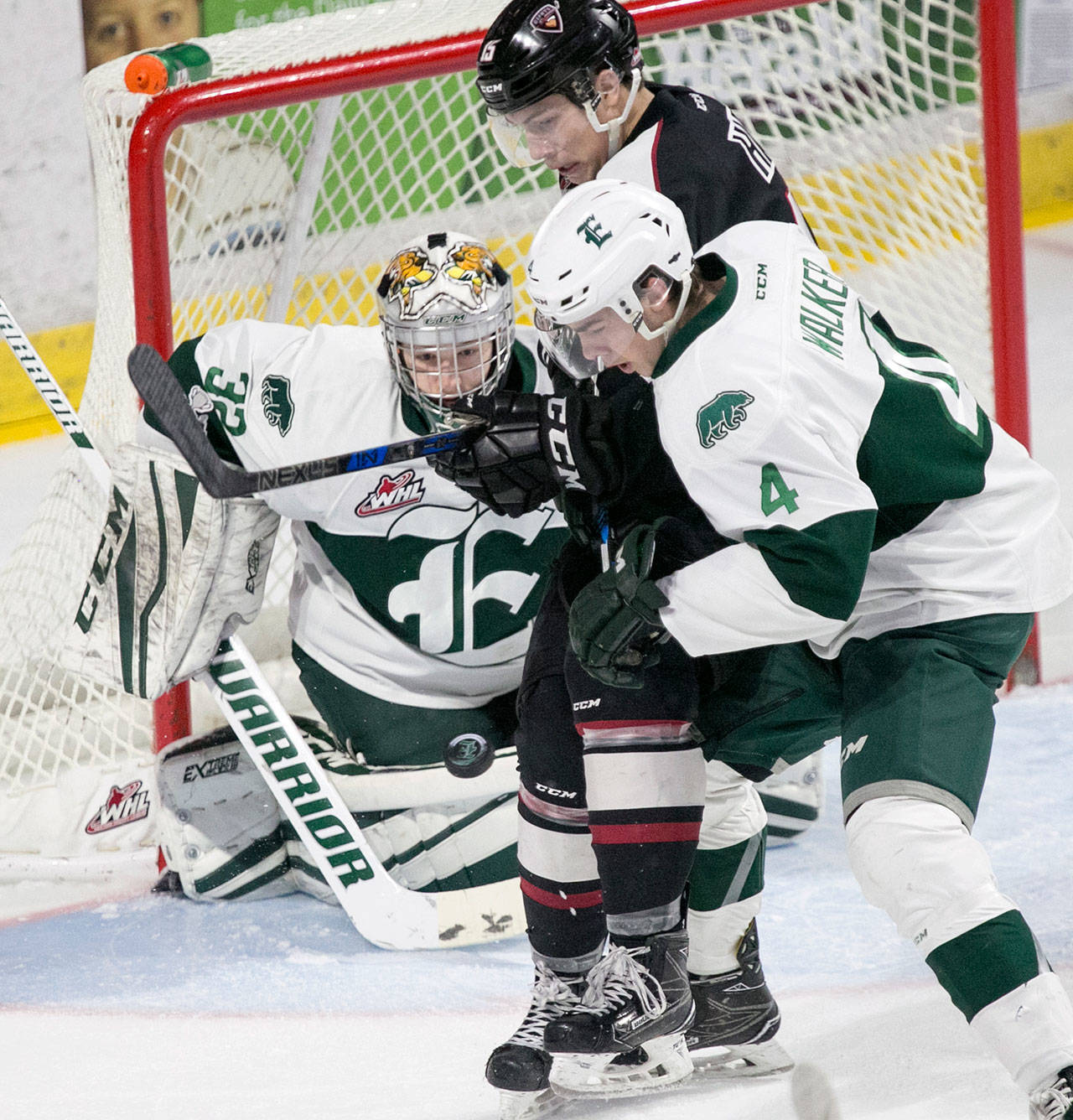 The Silvertips’ Ian Walker (right) and goalie Dustin Wolf (left) defends against Vancouver’s Owen Hardy (center) during a game on Dec. 29, 2017, at Angels of the Winds Arena in Everett. (Kevin Clark / The Daily Herald)