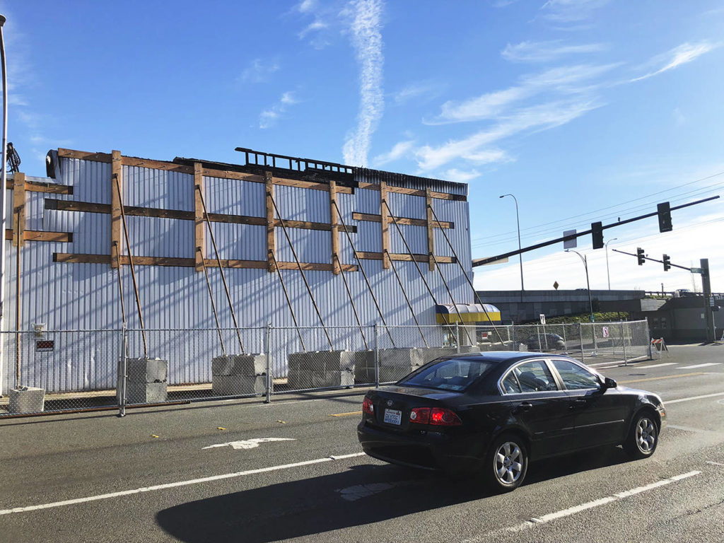 Almost four months after a fire at Judd & Black in Everett, police announced it was caused by arson. One lane of northbound Maple Street was still closed Wednesday at Hewitt Avenue. (Caleb Hutton / The Herald)
