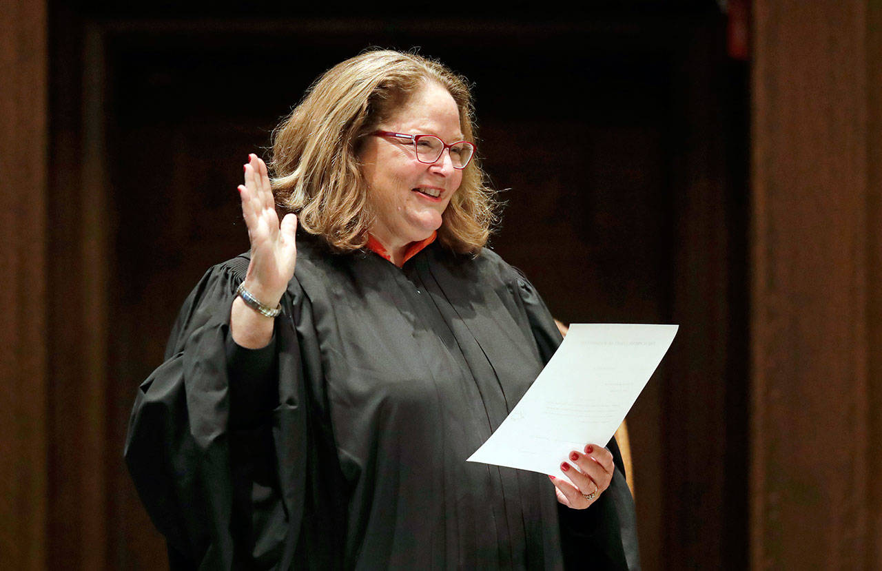 In this Jan. 14 photo, Washington State Supreme Court Chief Justice Mary Fairhurst administers the oath of office to re-elected Justice Susan Owens during a ceremony on opening day of the Washington Legislature at the Capitol in Olympia. (AP Photo/Ted S. Warren, File)