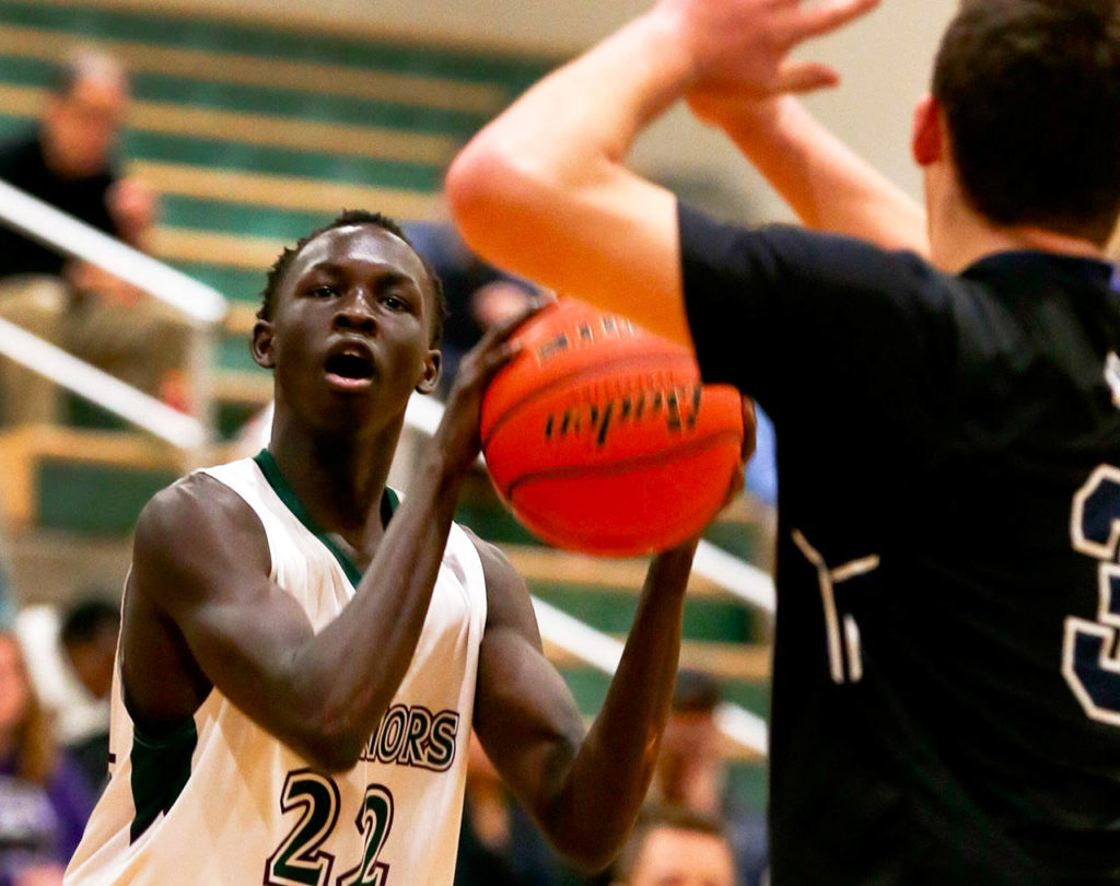 Edmonds-Woodway’s Mutdung Bol (left) attempts a shot with Arlington’s Griffin Gardoski closing during a game on Jan. 9, 2019, at Edmonds-Woodway High School. (Kevin Clark / The Herald)
