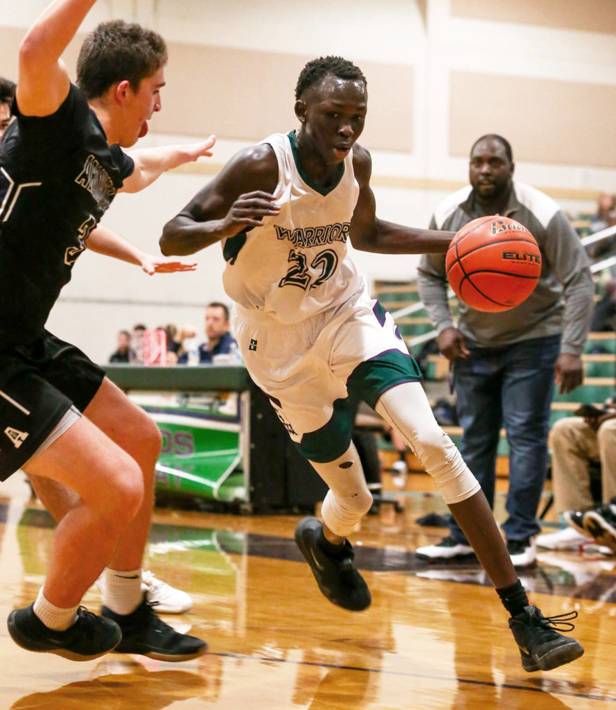 Edmonds-Woodway’s Mutdung Bol (right) controls the ball with Arlington’s Griffin Gardoski defending during a game on Jan. 9, 2019, at Edmonds-Woodway High School. (Kevin Clark / The Herald)

