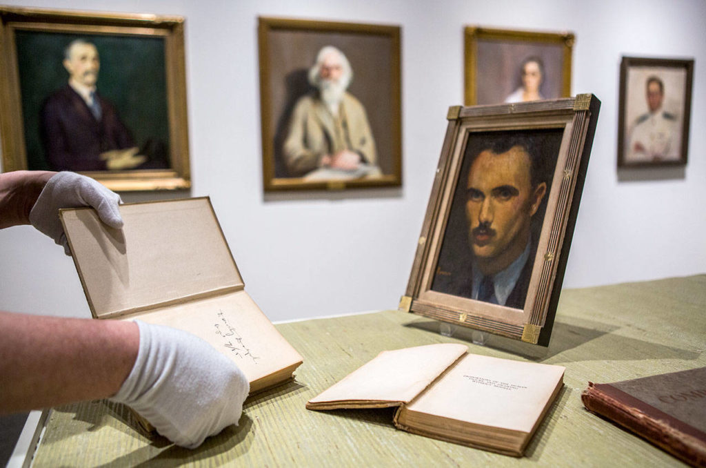 David Martin sets up a display case for the newest exhibit on Northwest art at the Cascadia Art Museum in Edmonds. (Olivia Vanni / The Herald)
