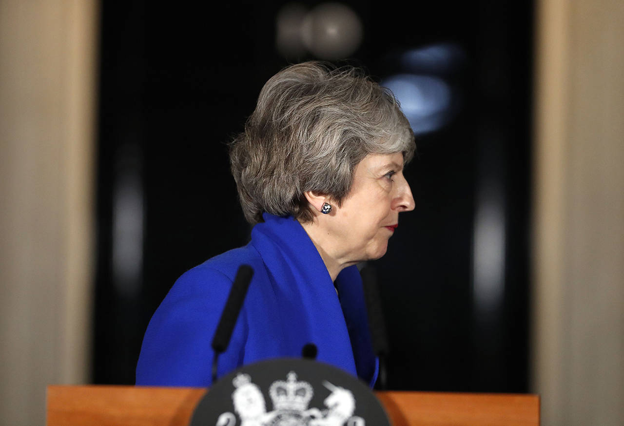 British Prime Minister Theresa May turns away after speaking outside 10 Downing street in London on Wednesday. May’s government survived a no-confidence vote Wednesday called after May’s Brexit deal was overwhelmingly rejected by lawmakers. (AP Photo/Frank Augstein)