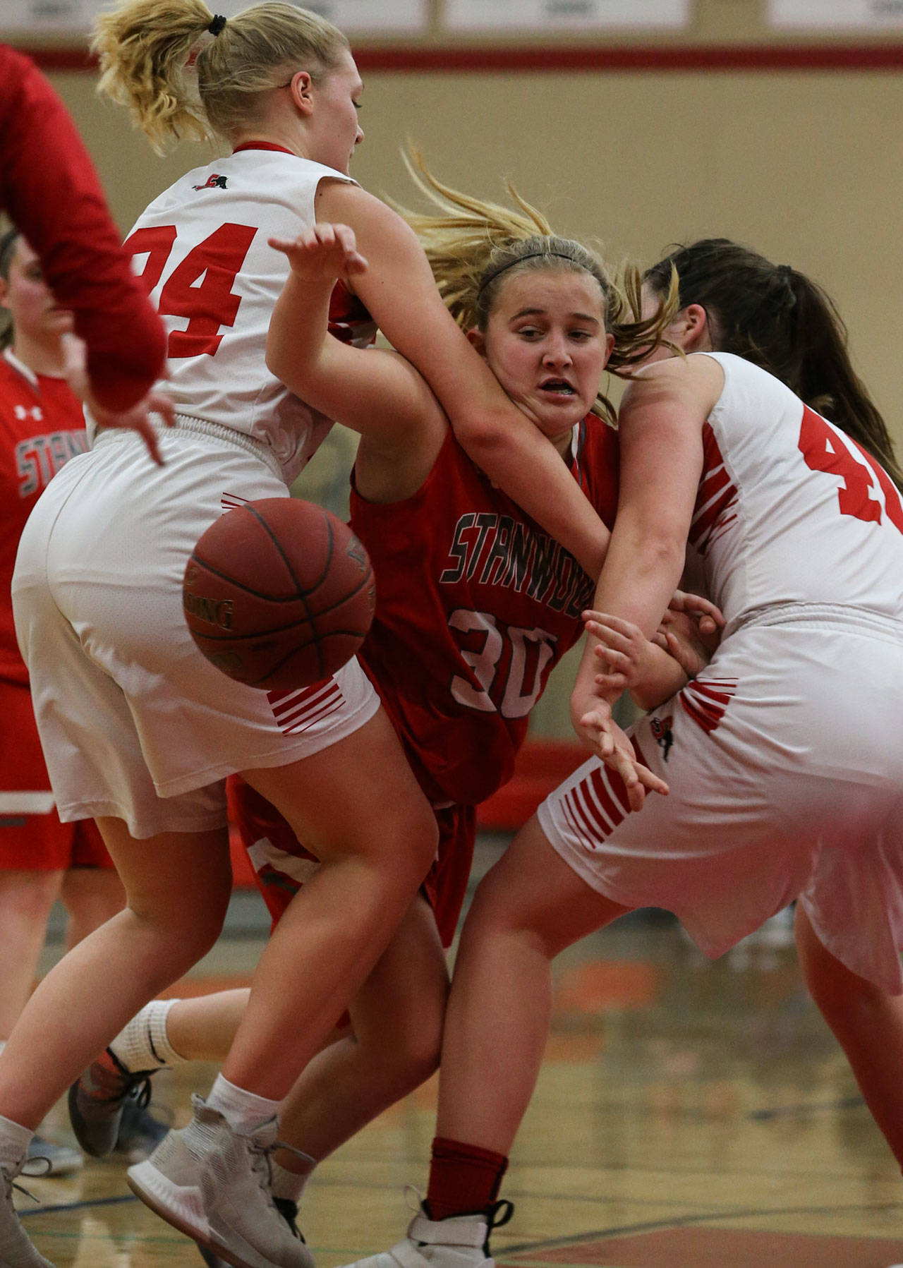 Stanwood’s Madeline Larson (center) tries to split the double team set by Snohomish’s Kaylin Beckman (left) and Courtney Perry (right) during a Wesco 3A girls basketball game Thursday in Snohomish. Snohomish (10-6, 9-1 Wesco 3A) locked down Stanwood (9-7, 6-4) during an 18-4 second quarter on its way to its fourth straight win. Maya DuChesne scored a game-high 16 poitns for the Panthers. (Kevin Clark / The Herald)