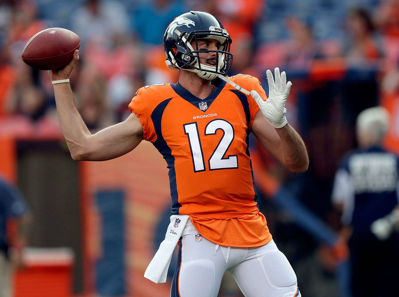 Quarterback Paxton Lynch (12) warms up prior to a preseason game between the Broncos and the Bears on Aug. 18, 2018, in Denver. (AP Photo/Jack Dempsey)