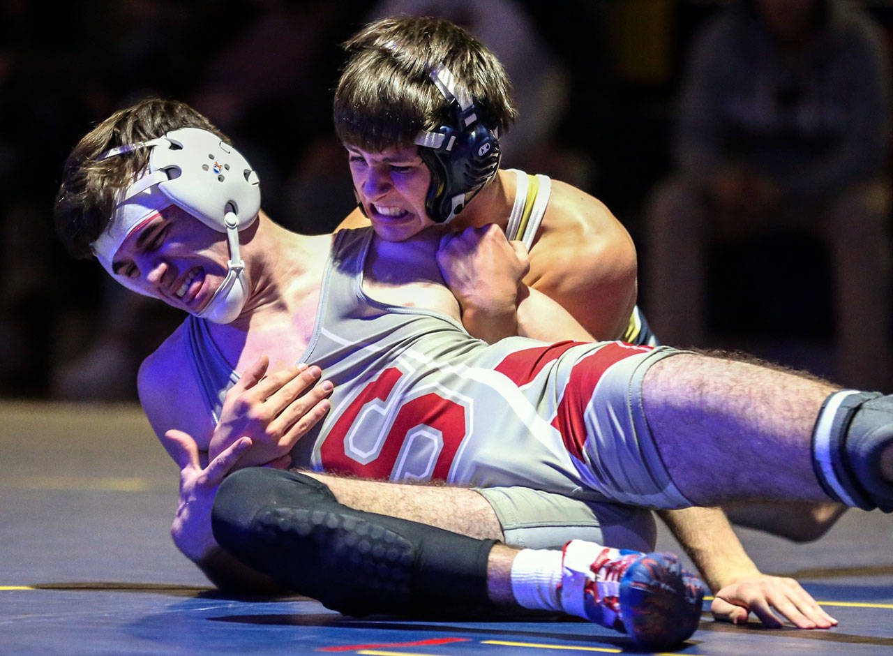 Stanwood’s Ben Woolman (front) tries to escape the grasp of Everett’s Dayne Tuohimaa in a bout at 145 pounds during a Wesco 3A North dual Friday in Everett. Tuohimaa beat Woolman 9-6 to help the Seagulls to a 49-24 win over the Spartans. (Kevin Clark / The Herald)