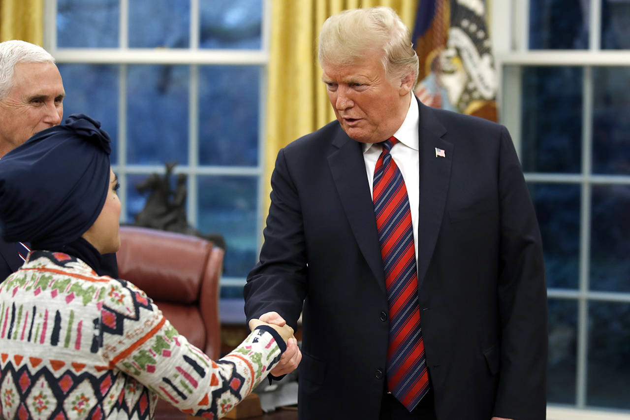 President Donald Trump greets people during a naturalization ceremony in the Oval Office of the White House on Saturday, before making a televised speech about his proposed border wall. (AP Photo/Alex Brandon)