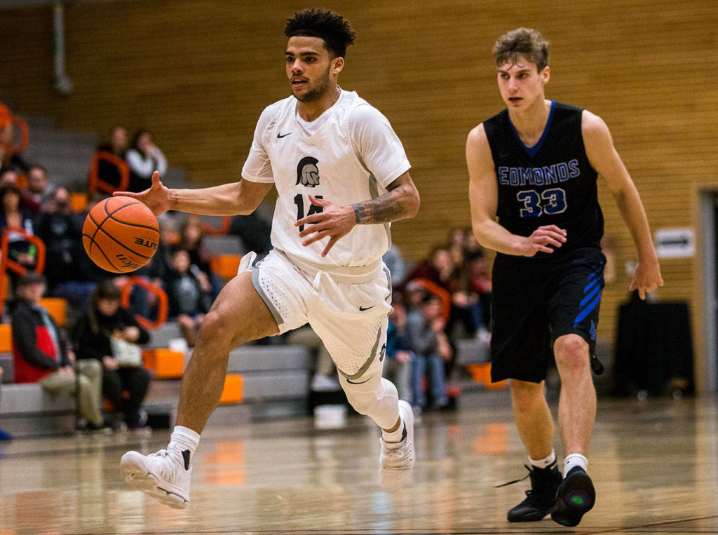 Everett’s Phalon Maddox (left) drives past Edmonds’ Brendan Hayes during a game on Jan. 19, 2019, in Everett. (Olivia Vanni / The Herald)
