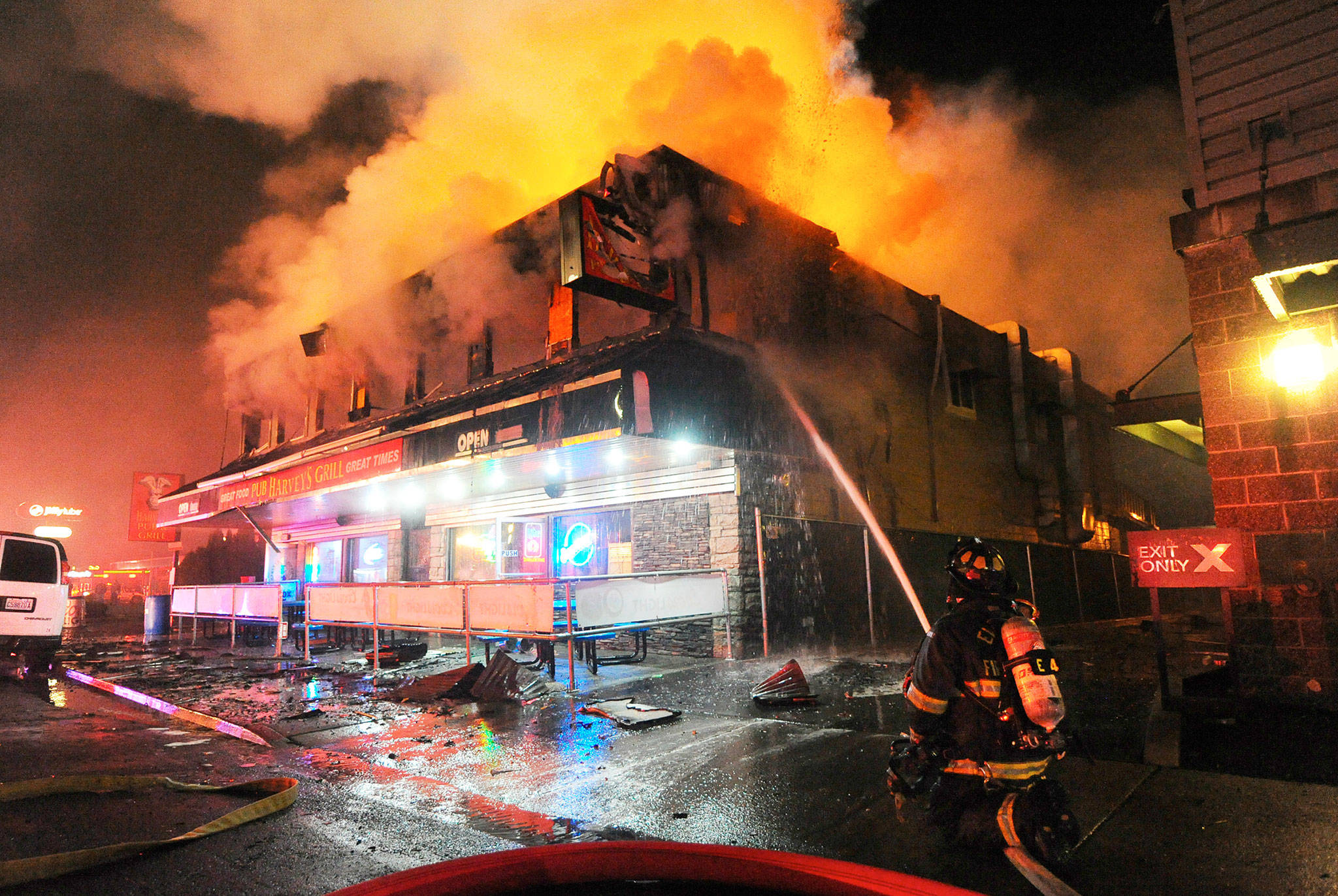 Firefighters tackle a two-alarm fire that gutted Harvey’s Pub early Sunday morning on Broadway in Everett. (Doug Ramsay / For The Herald)