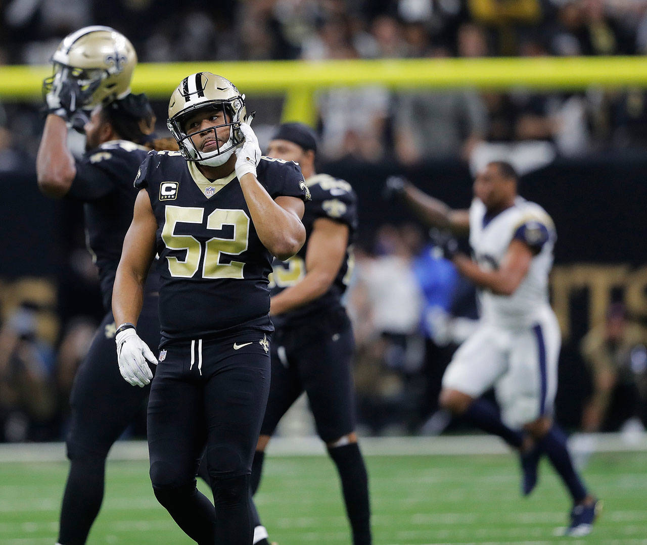 New Orleans Saints linebacker Craig Robertson (52) leaves the field as the Los Angeles Rams celebrate their 26-23 victory Sunday in the NFC championship game. (AP Photo/Gerald Herbert)