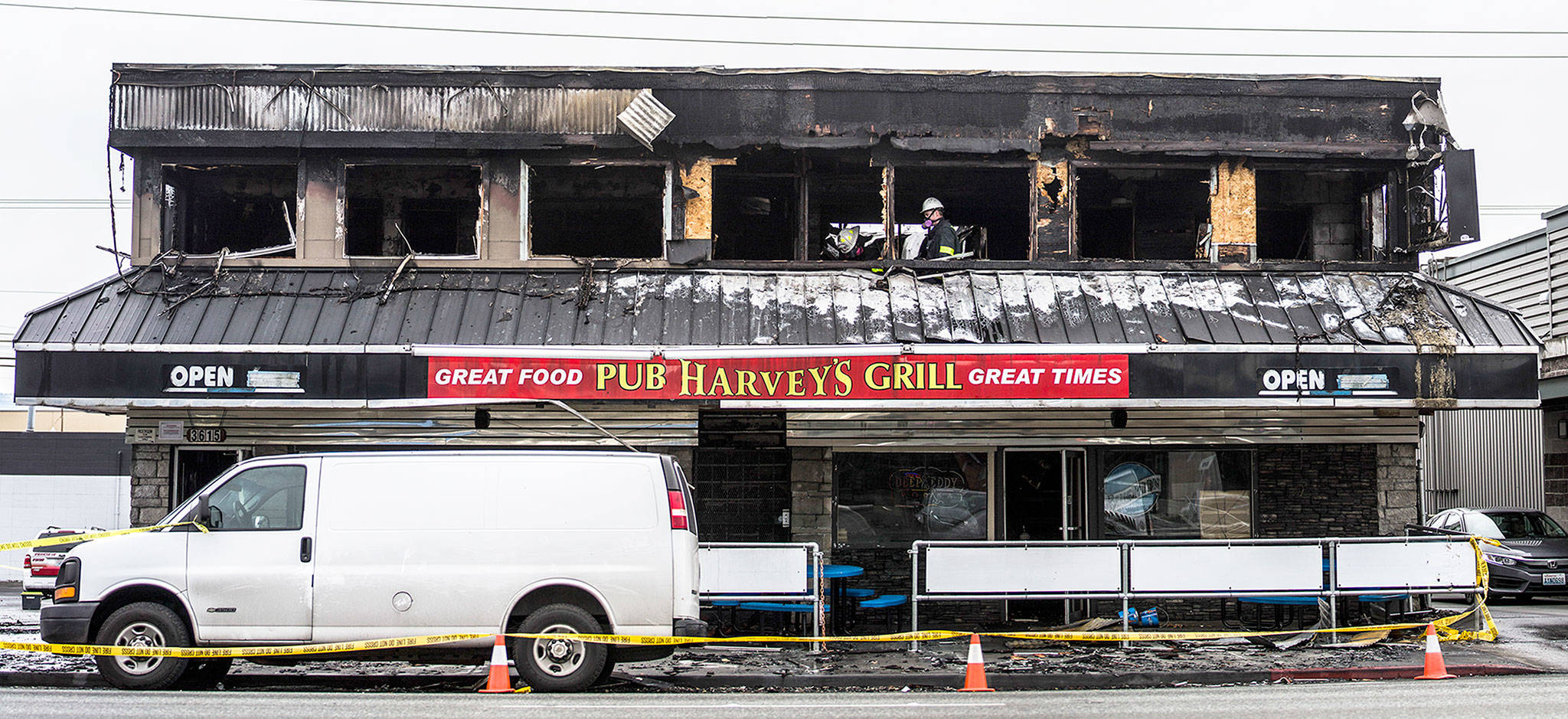 Everett fire investigators inspect Harvey’s Pub & Grill on Sunday. (Olivia Vanni / The Herald)