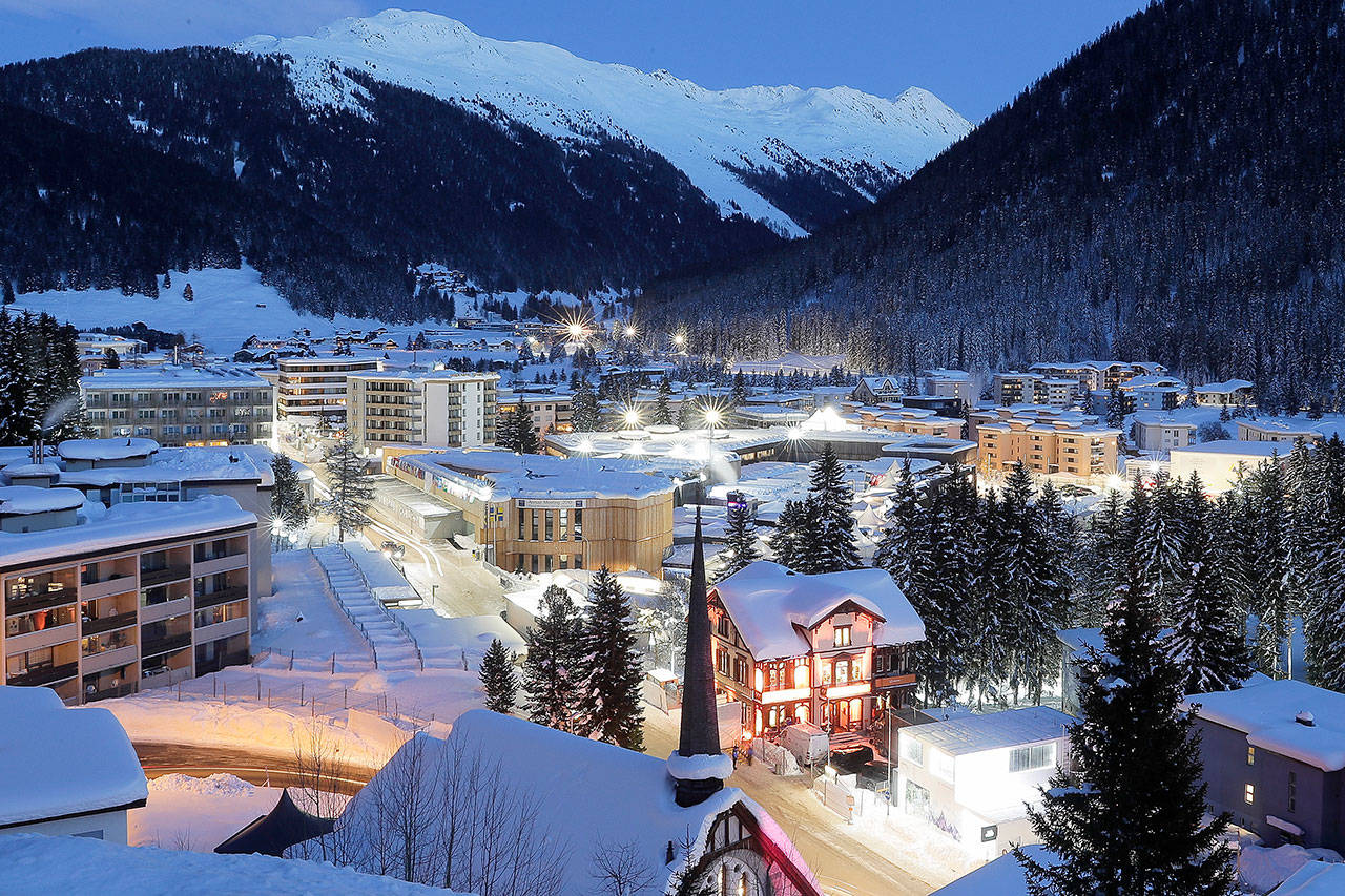 The congress center, the building in the middle, is illuminated by street lights on the eve of the annual World Economic Forum in Davos, Switzerland. (AP Photo/Markus Schreiber)