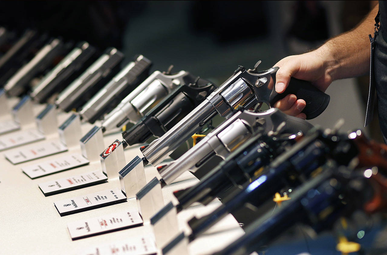 In this 2016 photo, handguns are displayed at the Smith & Wesson booth at the Shooting, Hunting and Outdoor Trade Show in Las Vegas. (AP Photo/John Locher, File)