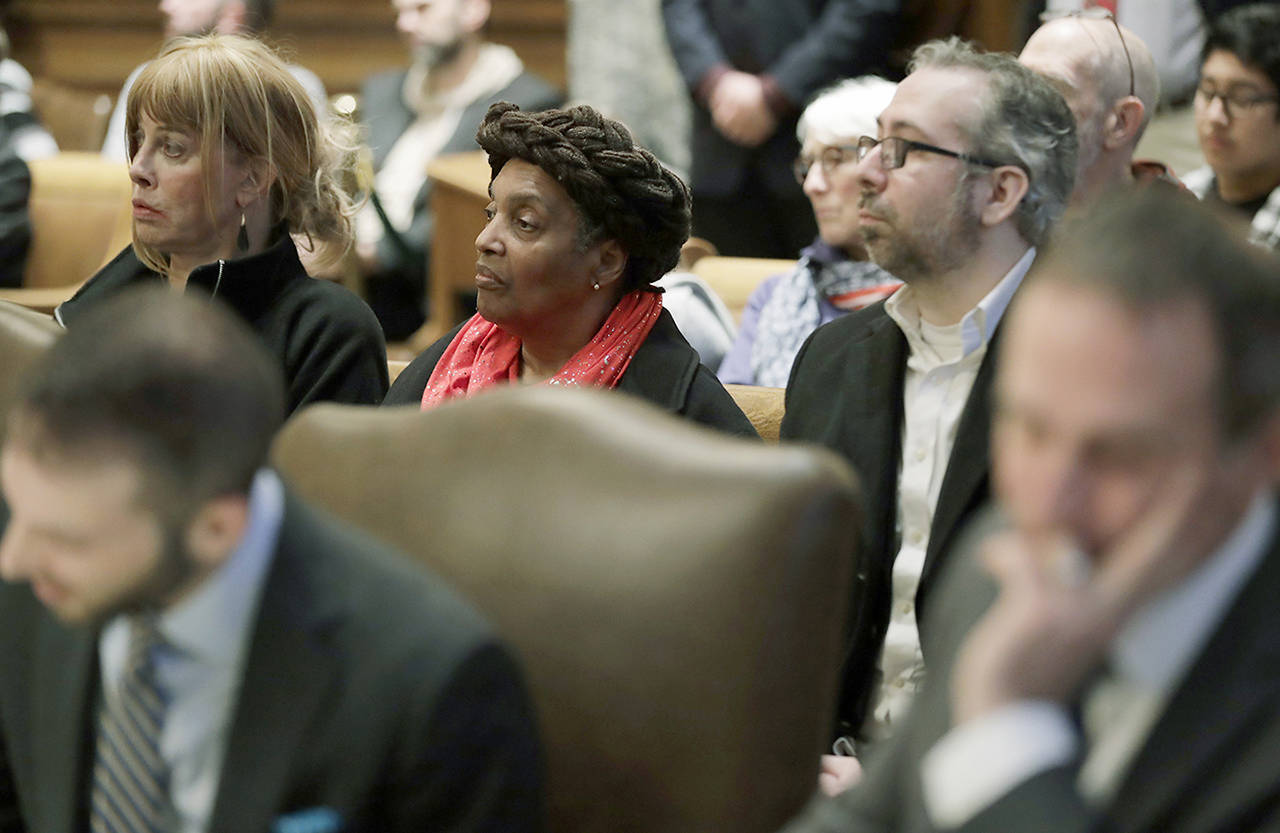 Washington state presidential electors Esther John (center) and Bret Chiafalo (right) sit behind their attorneys Tuesday during a Washington Supreme Court hearing in Olympia on a lawsuit addressing the constitutional freedom of electors to vote for any candidate for president, not just the nominee of their party. (AP Photo/Ted S. Warren)
