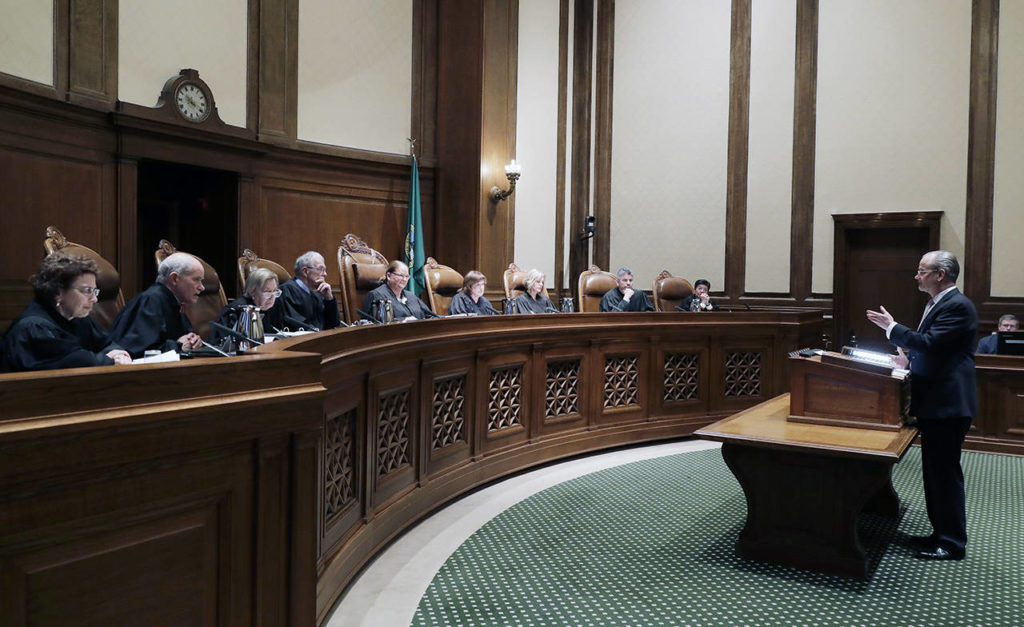 Lawrence Lessig (right), an attorney representing three Washington state presidential electors, speaks Tuesday during a Washington Supreme Court hearing in Olympia on a lawsuit addressing the constitutional freedom of electors to vote for any candidate for president, not just the nominee of their party. (AP Photo/Ted S. Warren)
