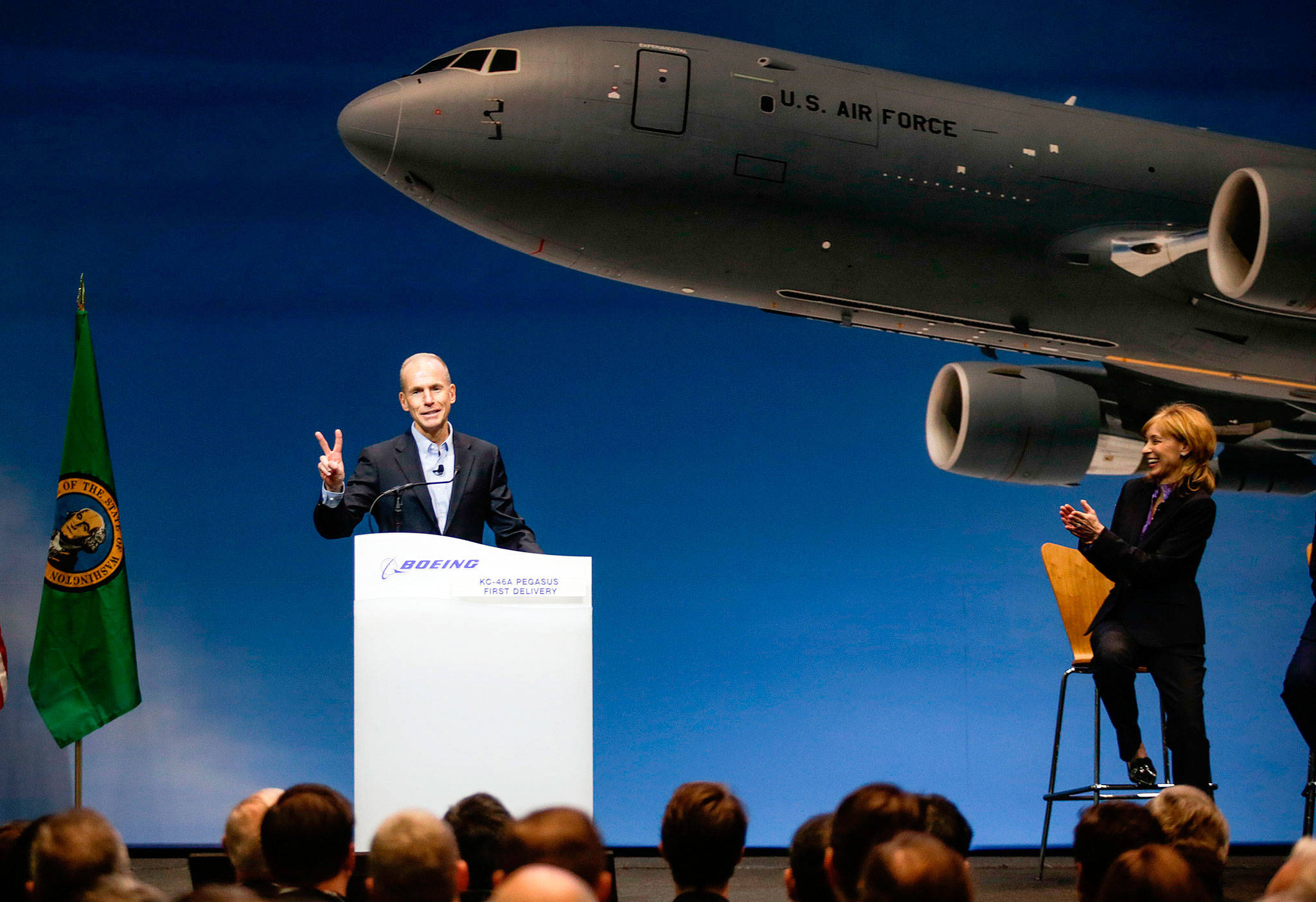 Company Chairman, President and CEO Dennis Muilenburg (left) gets a laugh on Thursday at the Boeing factory at Paine Field in Everett as he points out that two KC-46 Pegasus planes would be delivered to the U.S. Air Force. (Andy Bronson / The Herald)