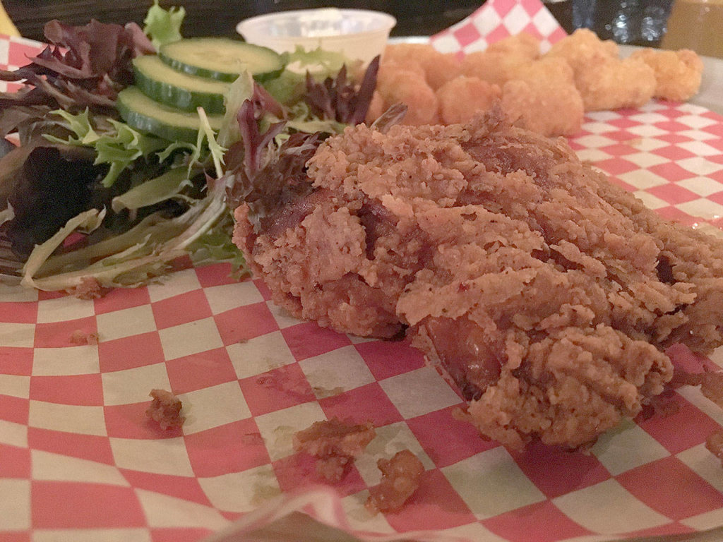 An order of the crispy fried chicken comes with a small salad, tater tots, two drumsticks and a breast at That Chicken Place in Everett. The breading was delightfully crunchy and the meat was impeccably juicy. (Ben Watanabe / The Herald)
