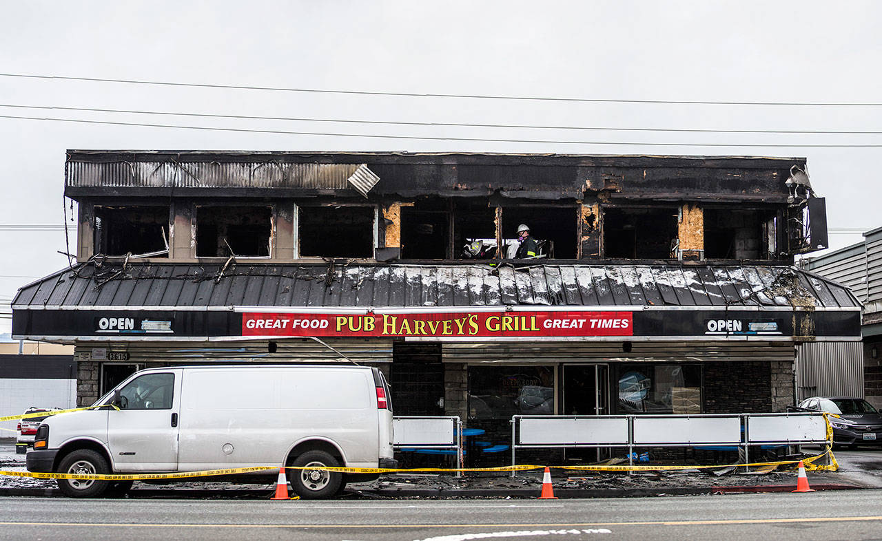 Everett fire investigators inspect Harvey’s Pub Grill on Sunday. (Olivia Vanni / The Herald)