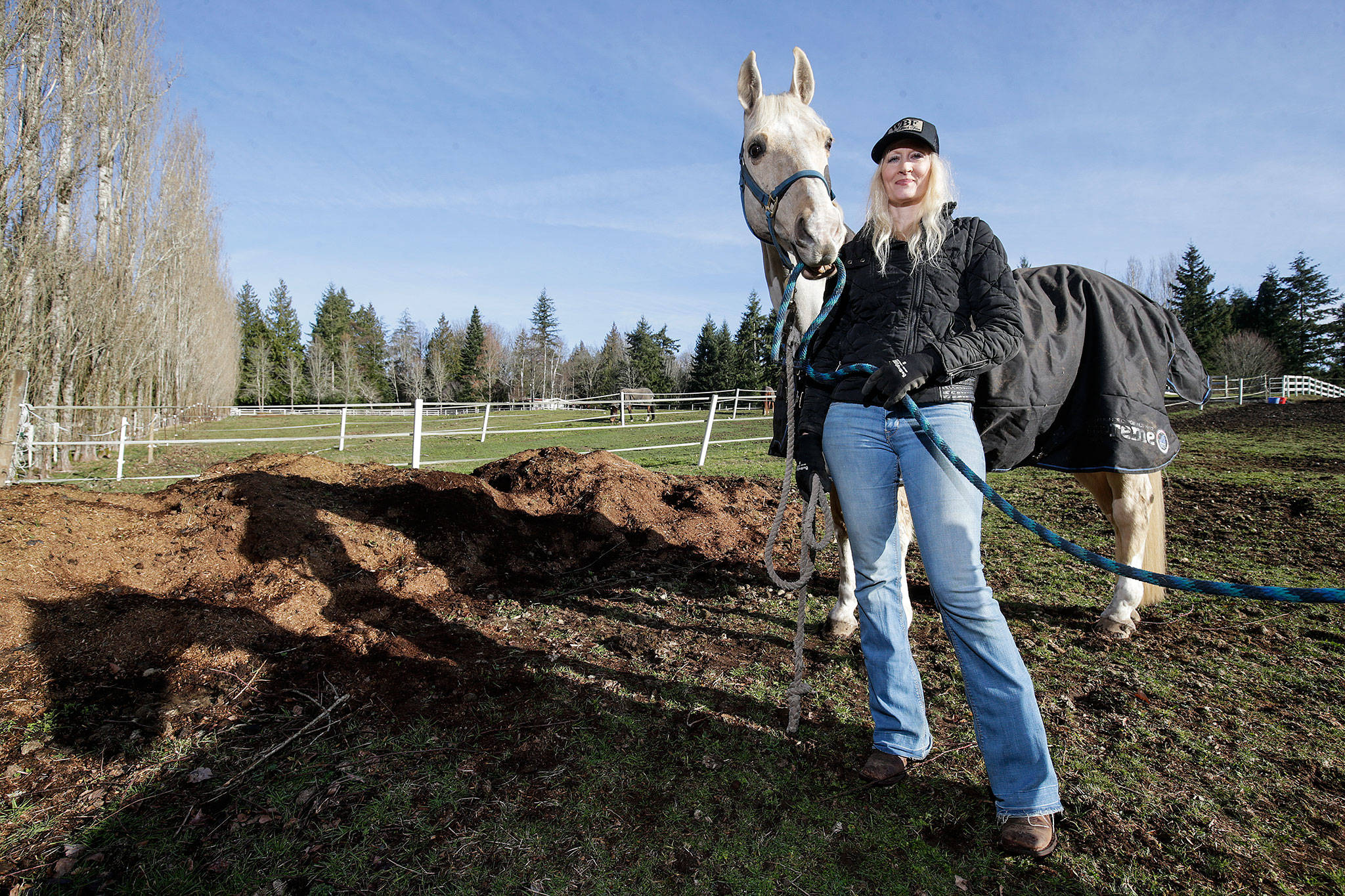 With her horse, Joe, next to her, Melonie Rainey, of White Birch Farm on the Tulalip Indian Reservation, talks Monday about her participation in the Conservation District’s horse manure spreading program. The program helps horse owners keep manure under control, turn it into fertilizer and use it on their pastures. (Andy Bronson / The Herald)