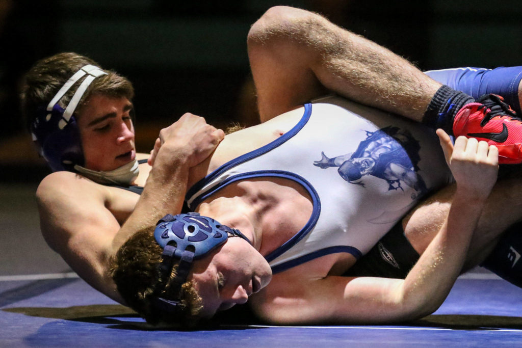 Granite Falls’ Hayden Long (left) works to pin Sultan’s Michael Moss during a meet on Jan. 24, 2019, at Sultan High School. (Kevin Clark / The Herald)
