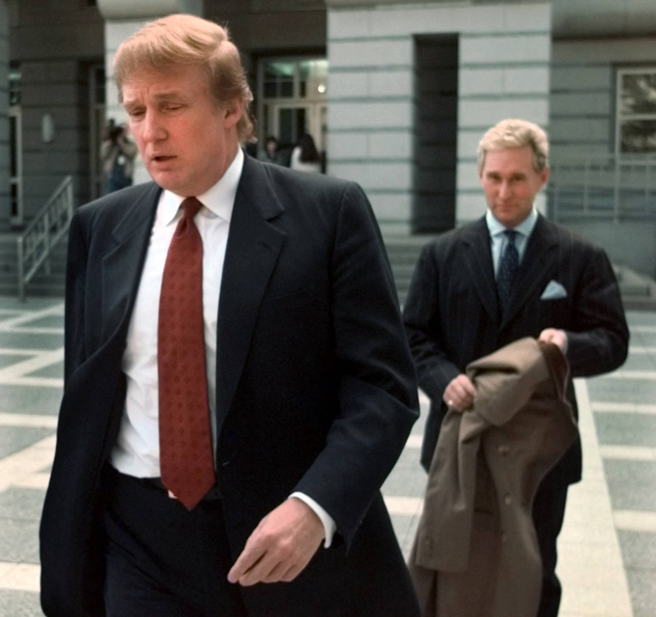 Billionaire real estate developer Donald Trump (left) walks to the Federal Courthouse in Newark, New Jersey, with Roger Stone, the director of Trump’s presidential exploratory committee, on Oct. 25, 1999, for the swearing-in of Trump’s sister as a federal appeals court judge. (AP Photo/Daniel Hulshizer)