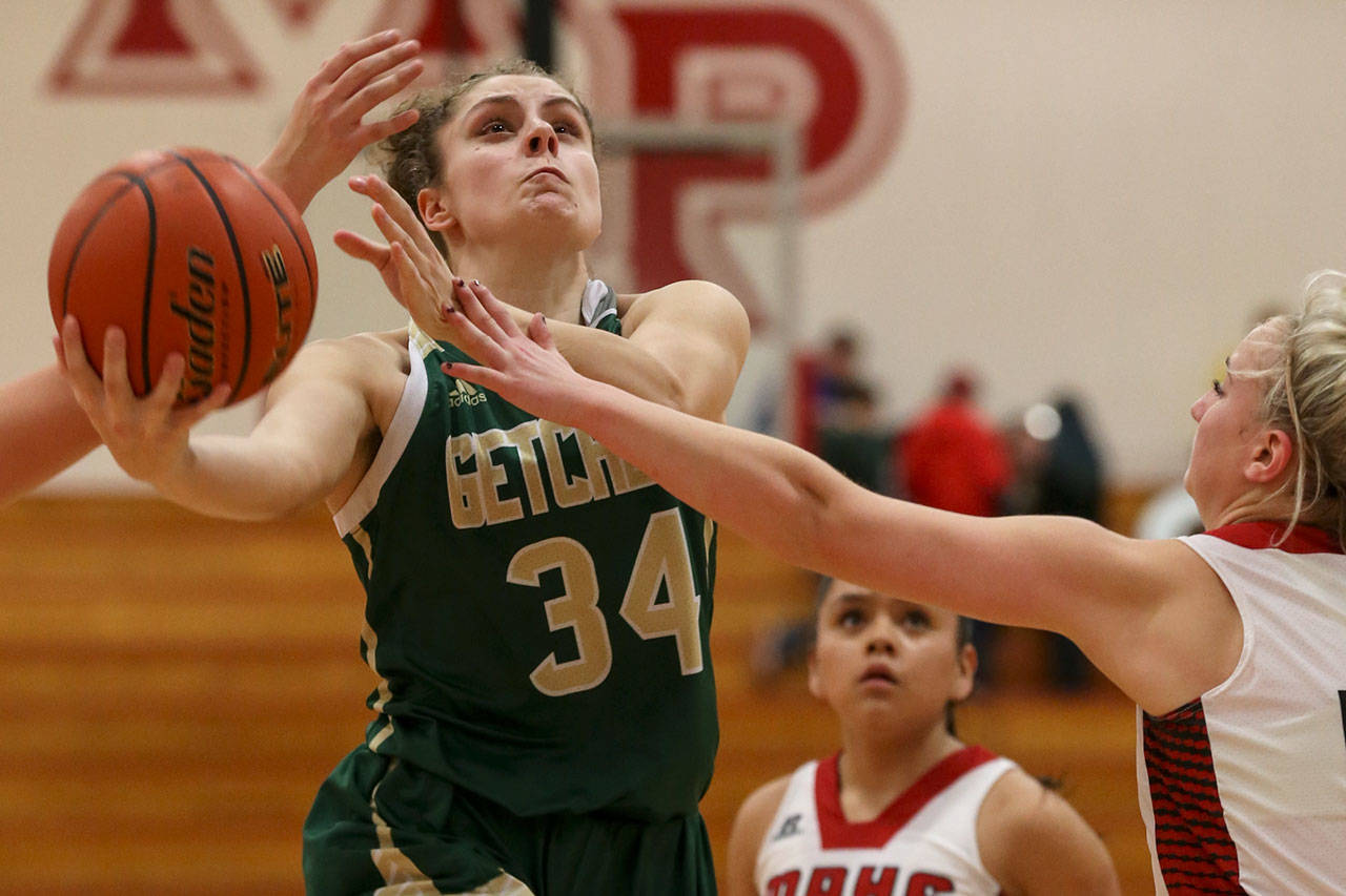 Marysville Getchell’s Maddy Grandbois attempts a shot with Marysville Pilchuck’s MacKenzie Konsor (right) reaching in at Marysville Pilchuck High School on Friday. The Chargers won 62-15. (Kevin Clark / The Herald)