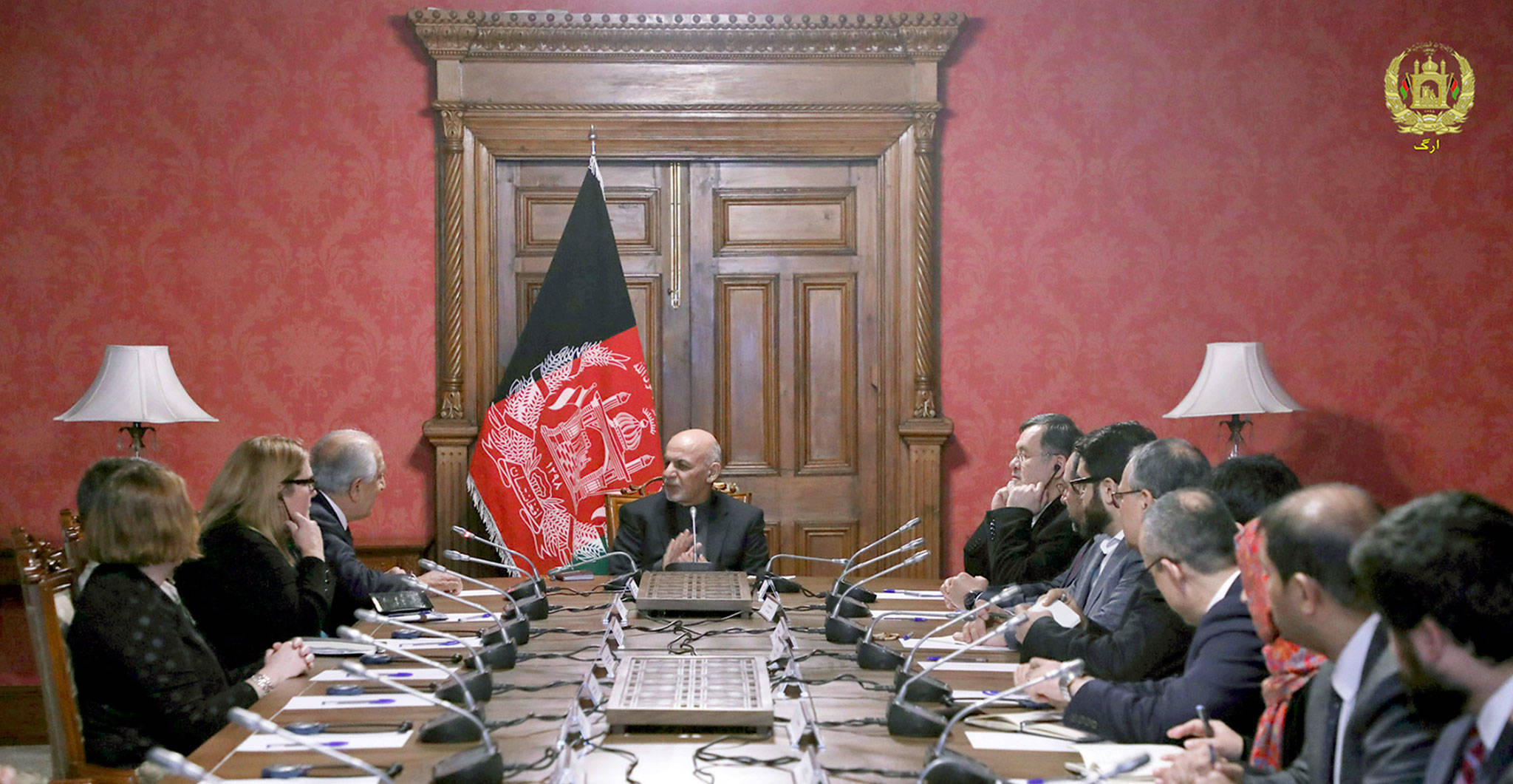 Afghan President Ashraf Ghani (center,0 speaks to U.S. peace envoy Zalmay Khalilzad (third from left) at the presidential palace in Kabul, Afghanistan, on Monday. (Afghan Presidential Palace via AP)