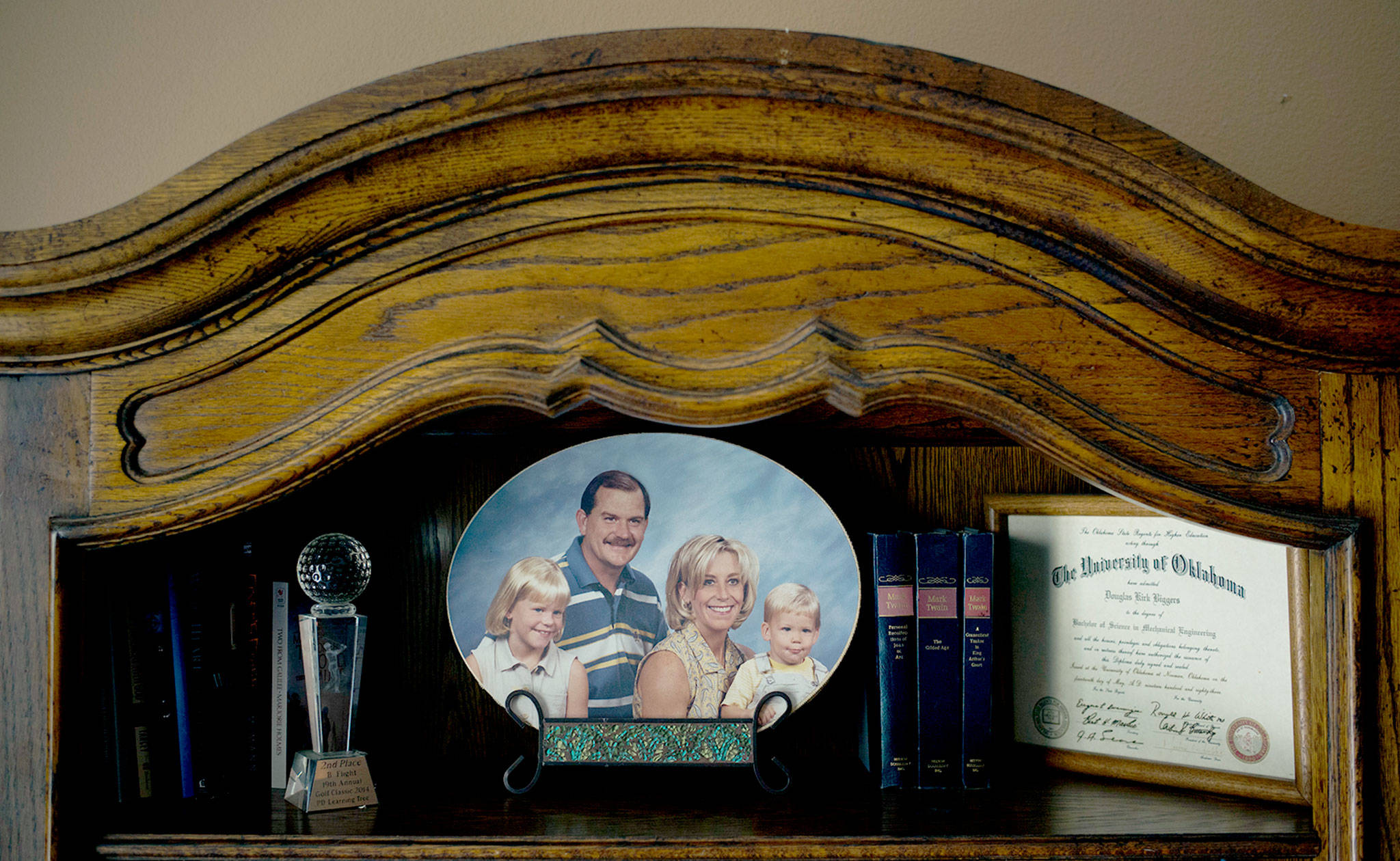 Landon Biggers sits on his mother’s lap in an old family photo in his father’s home office in La Quinta, California. He died in 2017 of a heroin overdose at the age of 20. (AP Photo/Jae C. Hong)