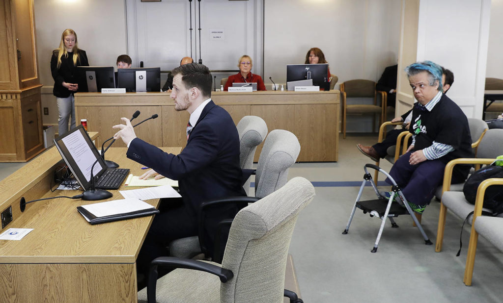 Peter Reckendorf (right), of Everett, listens as attorney Paul Boudreaux (left), who represents a company that puts on theatrical wrestling shows featuring performers with dwarfism, testifies before the Senate Law and Justice Committee of the Washington Legislature in Olympia. (AP Photo/Ted S. Warren) 
