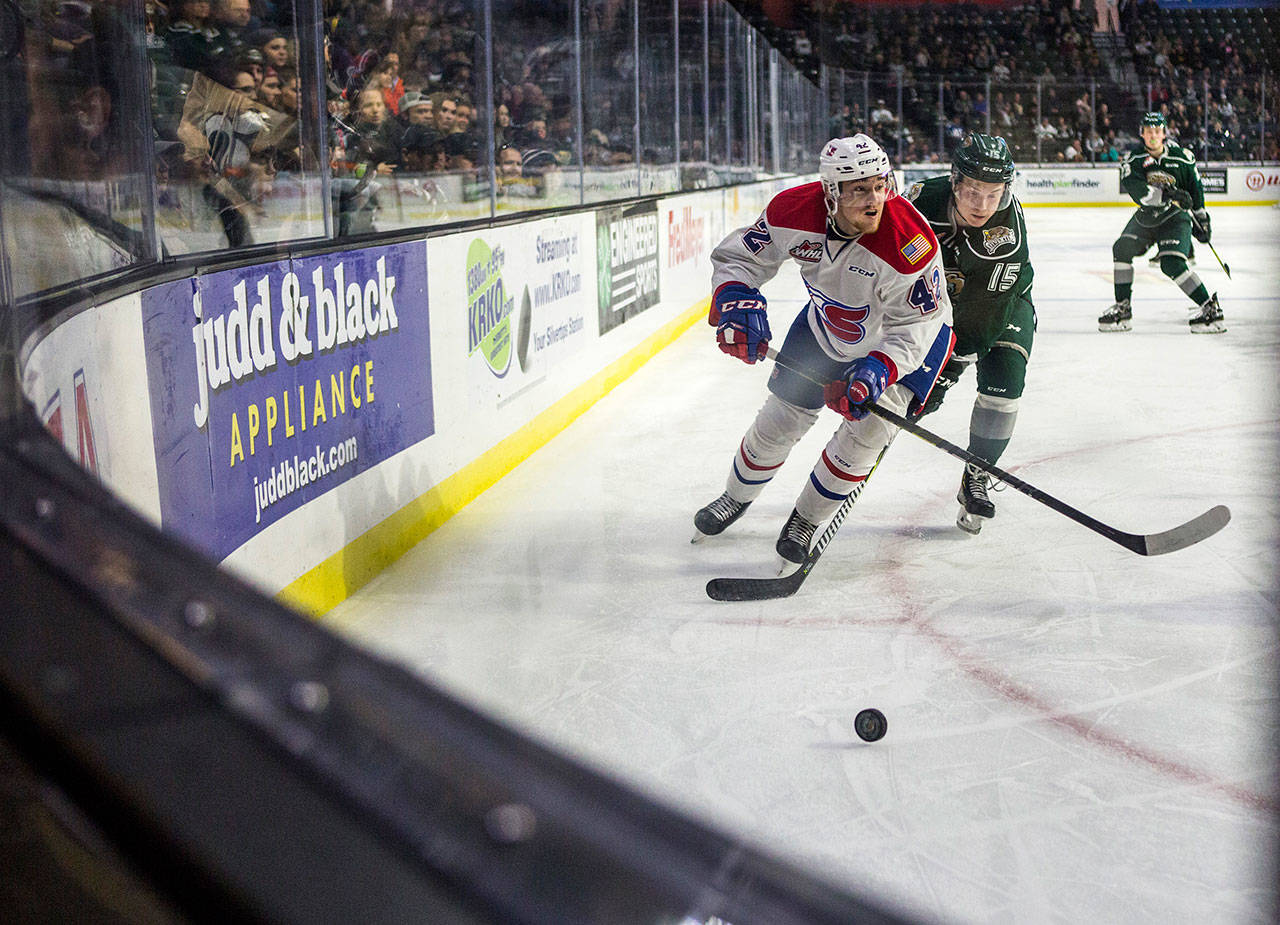 Everett’s Sean Richards (right) and Spokane’s Egor Arbuzov skate after the puck during a Nov. 18 game at Angel of the Winds Arena. (Olivia Vanni / The Herald)