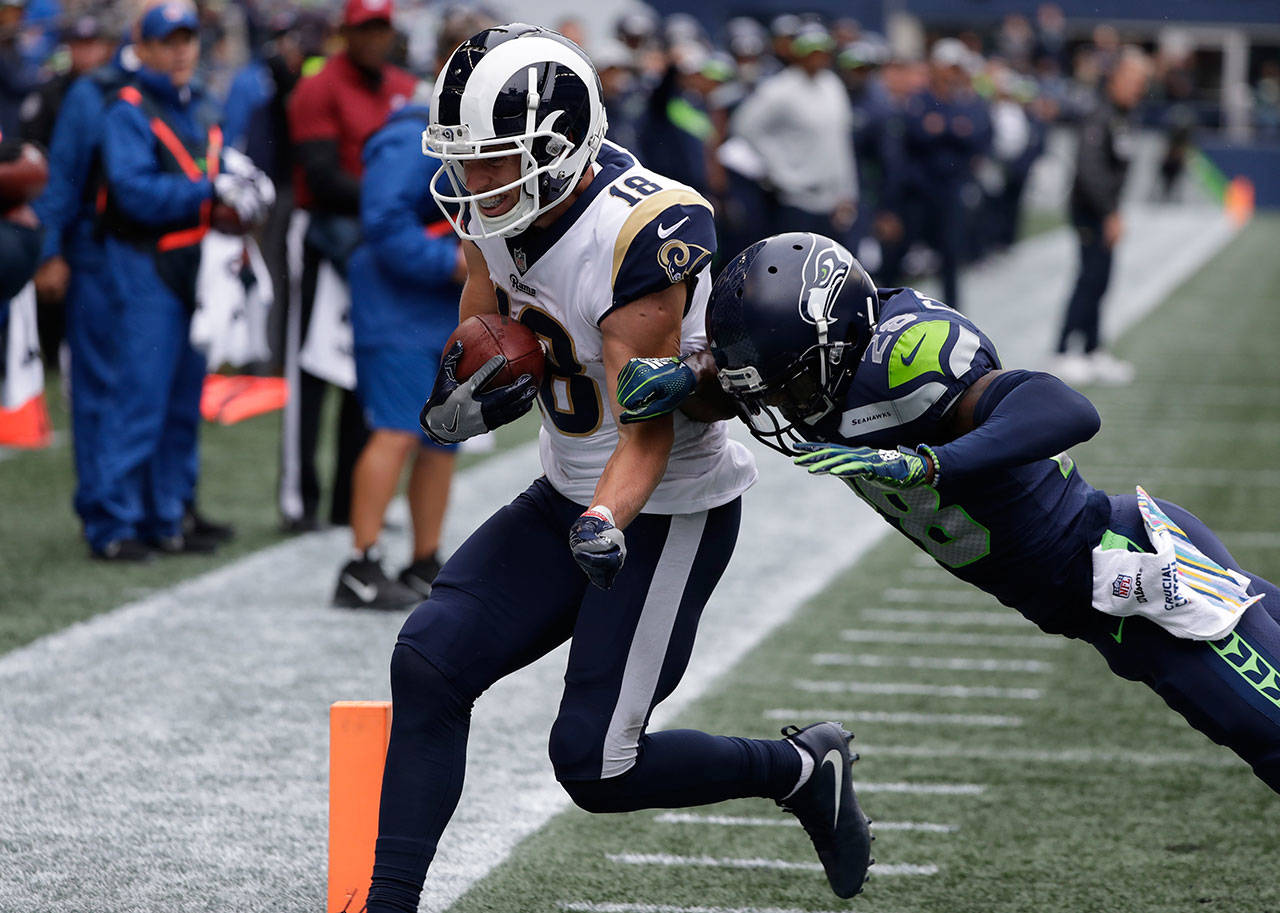 Rams wide receiver Cooper Kupp (left) scores a touchdown ahead of Seahawks cornerback Justin Coleman on Oct. 7, 2018, in Seattle. (AP Photo/Elaine Thompson)