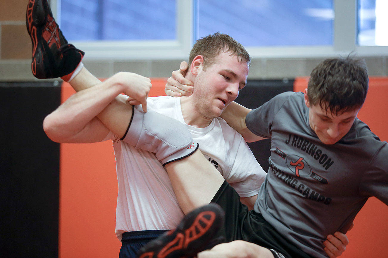 Archbishop Murphy senior wrestler Devin Moore takes down teammate Colin Howell during practice on Monday, Jan. 21, 2019 in Everett, Wa. (Andy Bronson / The Herald)