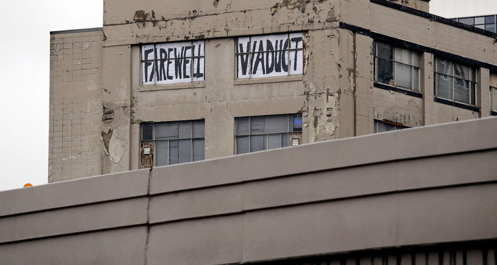 A “Farewell Viaduct” sign stands in view of the north portal of the new State Route 99 tunnel on Friday. The two-mile, double-deck highway running under downtown is set to open to traffic Monday, Feb. 4, and replaces the old Alaskan Way Viaduct, damaged in an earthquake in 2001. (AP Photo/Elaine Thompson)

