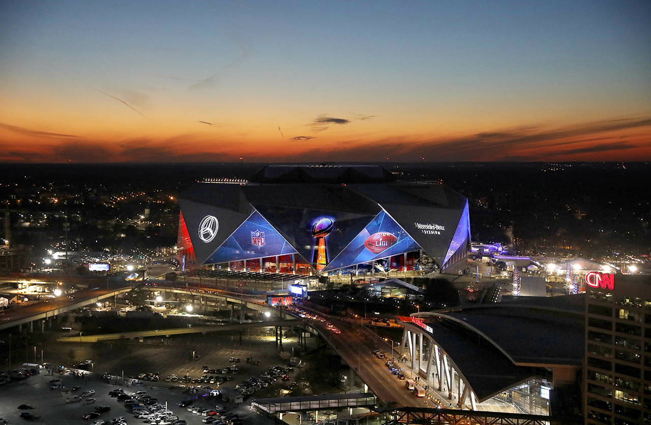 The sun sets behind Mercedes-Benz Stadium ahead of Sunday’s NFL Super Bowl 53 football game between the Los Angeles Rams and New England Patriots in Atlanta, on Wednesday. (AP Photo/David Goldman)